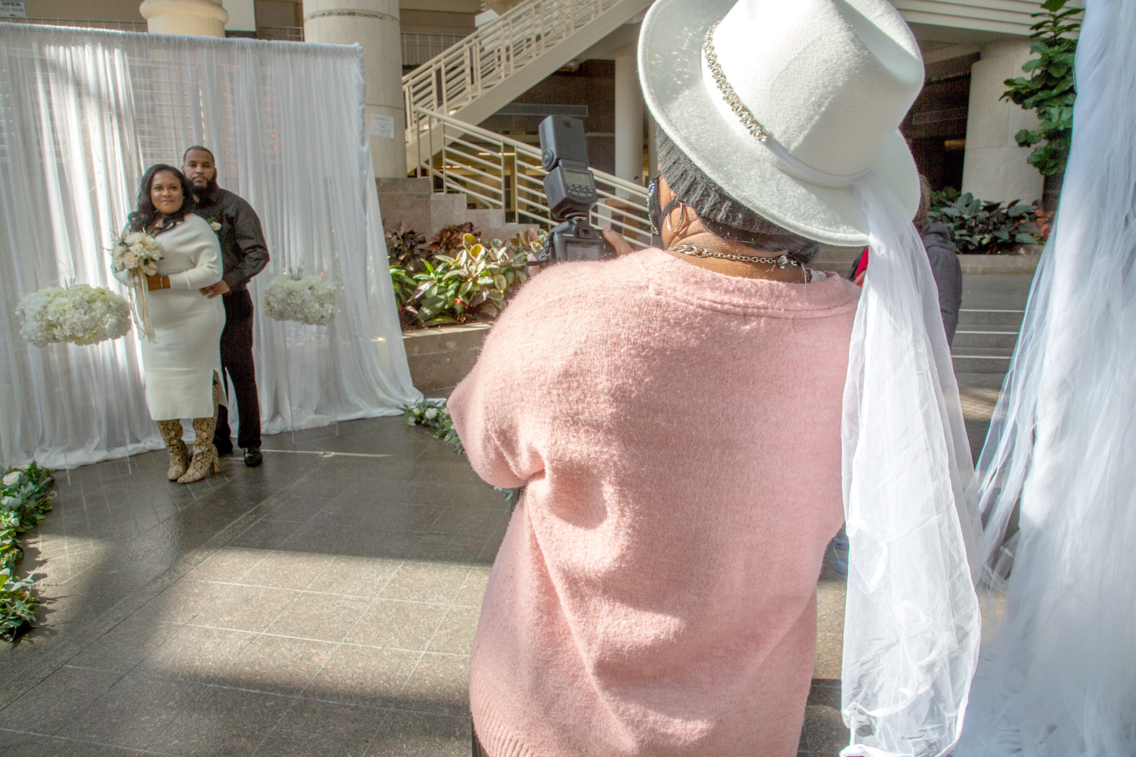 Cathia Thomas And her new husband Michael pose for pictures after getting married in the Atrium of the Fulton County Gov. Bldg. on valentines day, February 14, 2022. STEVE SCHAEFER FOR THE ATLANTA JOURNAL-CONSTITUTION