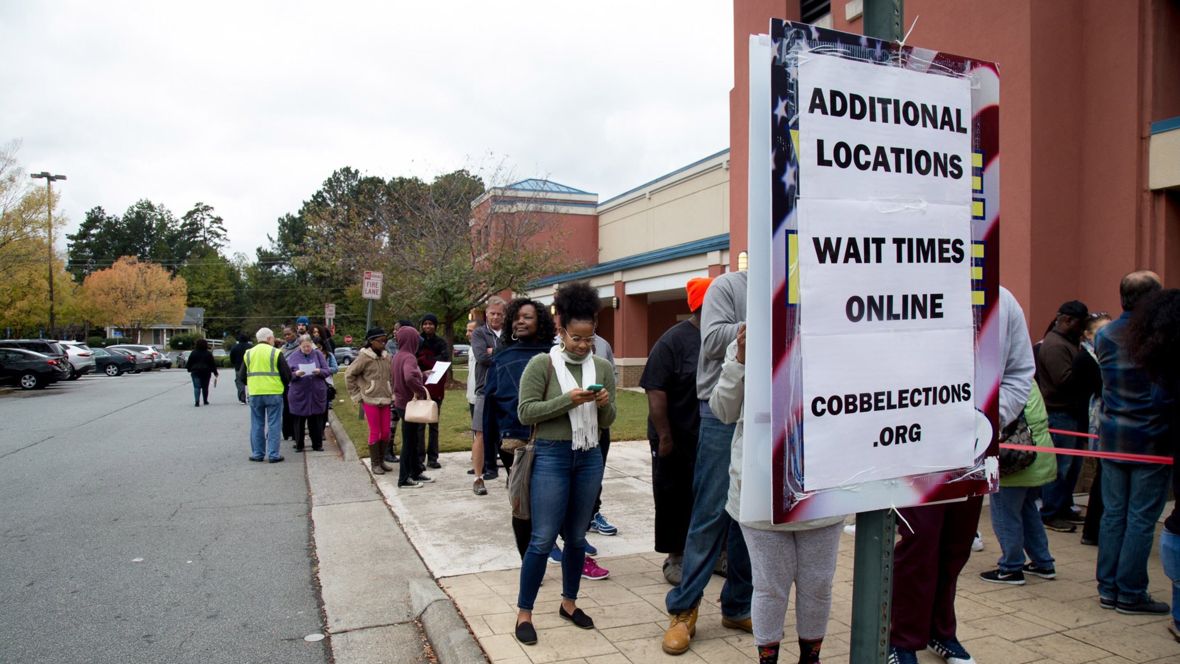 People wait in a long line to vote Saturday at the Cobb County Board of Elections and Registration Office in Marietta. STEVE SCHAEFER / SPECIAL TO THE AJC
