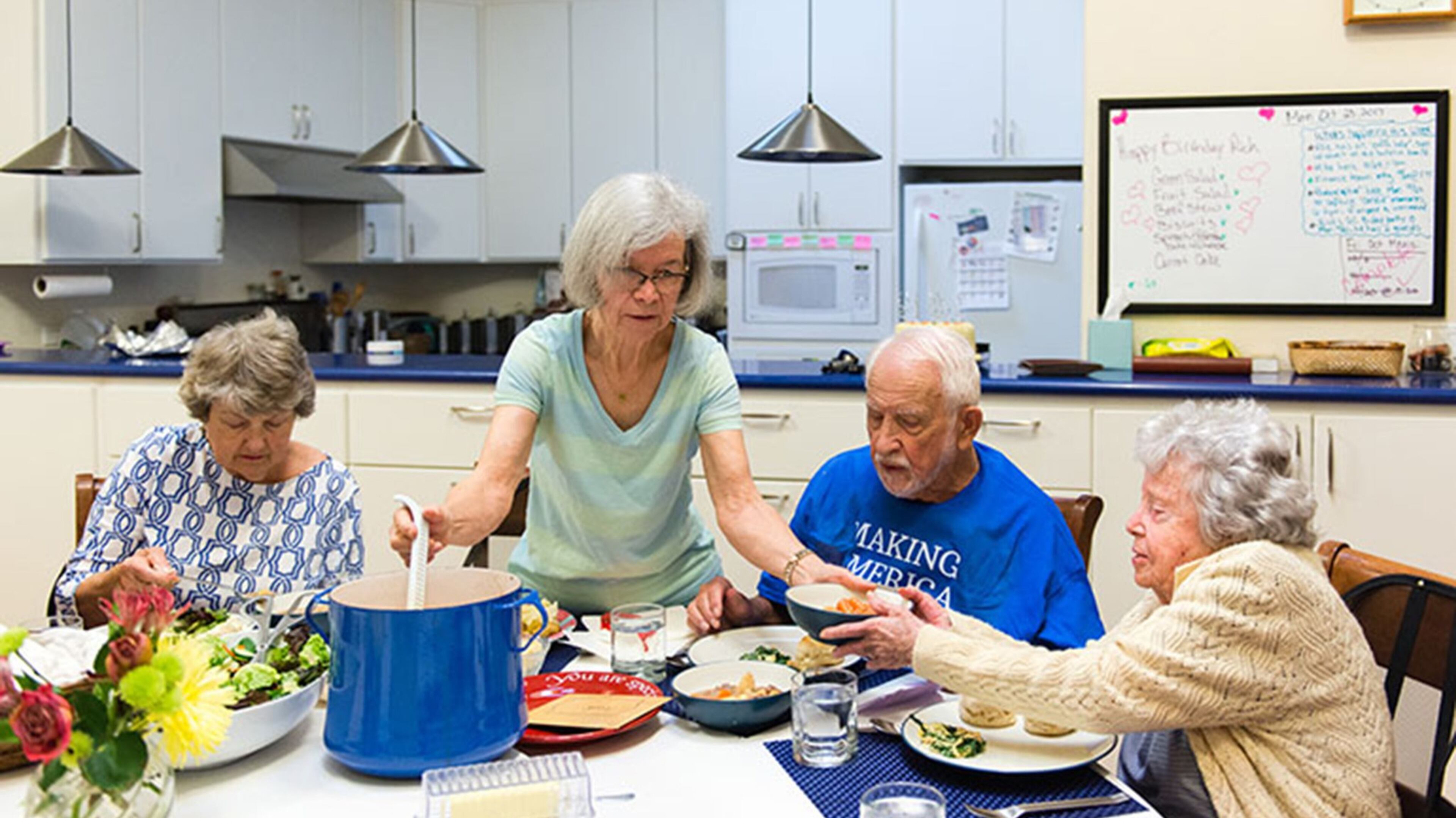 Carolyn Langenkamp, 68, helps serve the family-style dinner on Oct. 23, 2017. (Heidi de Marco/KHN)