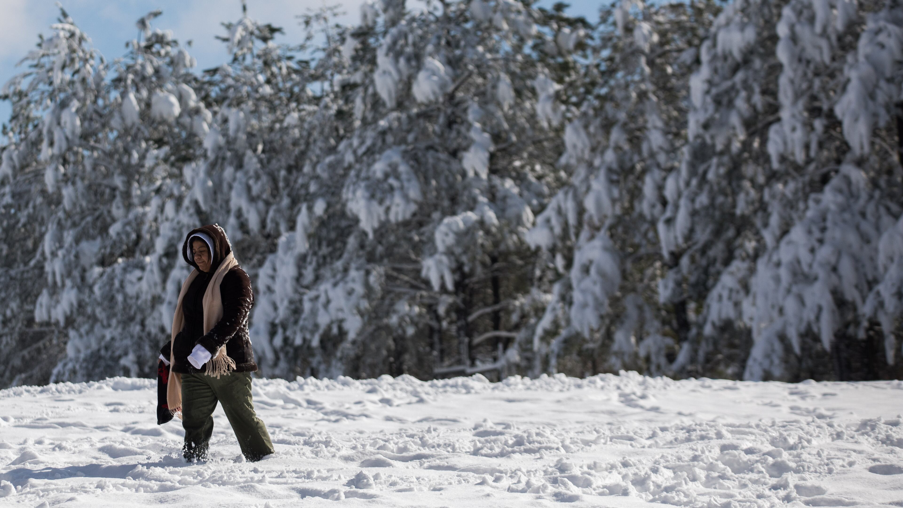 A woman walks in a snow-covered field in Acworth on Saturday, Dec. 9, 2017, after a snowstorm hit metro Atlanta and North Georgia on Friday and into Saturday morning.