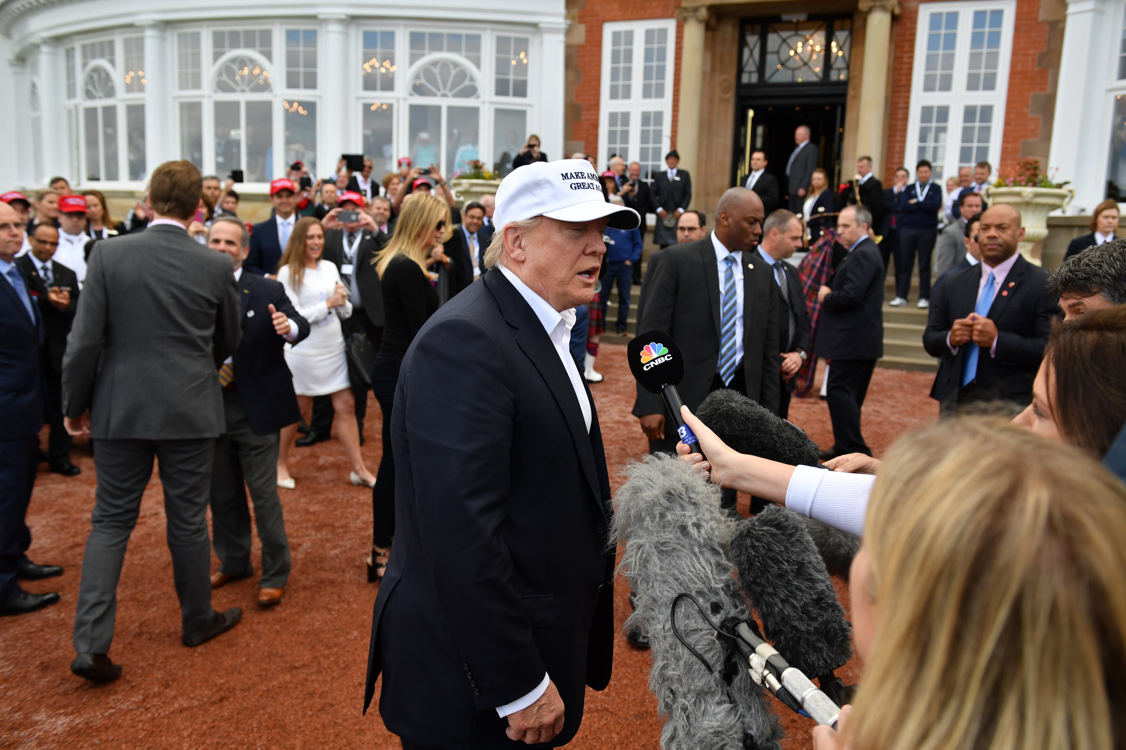Presumptive Republican nominee for US president Donald Trump speaks to CNBC news media as he arrives to his Trump Turnberry Resort on June 24, 2016 in Ayr, Scotland. Mr Trump arrived to officially open his golf resort which has undergone an eight month refurbishment as part of an investment thought to be worth in the region of two hundred million pounds. (Photo by Jeff J Mitchell/Getty Images)