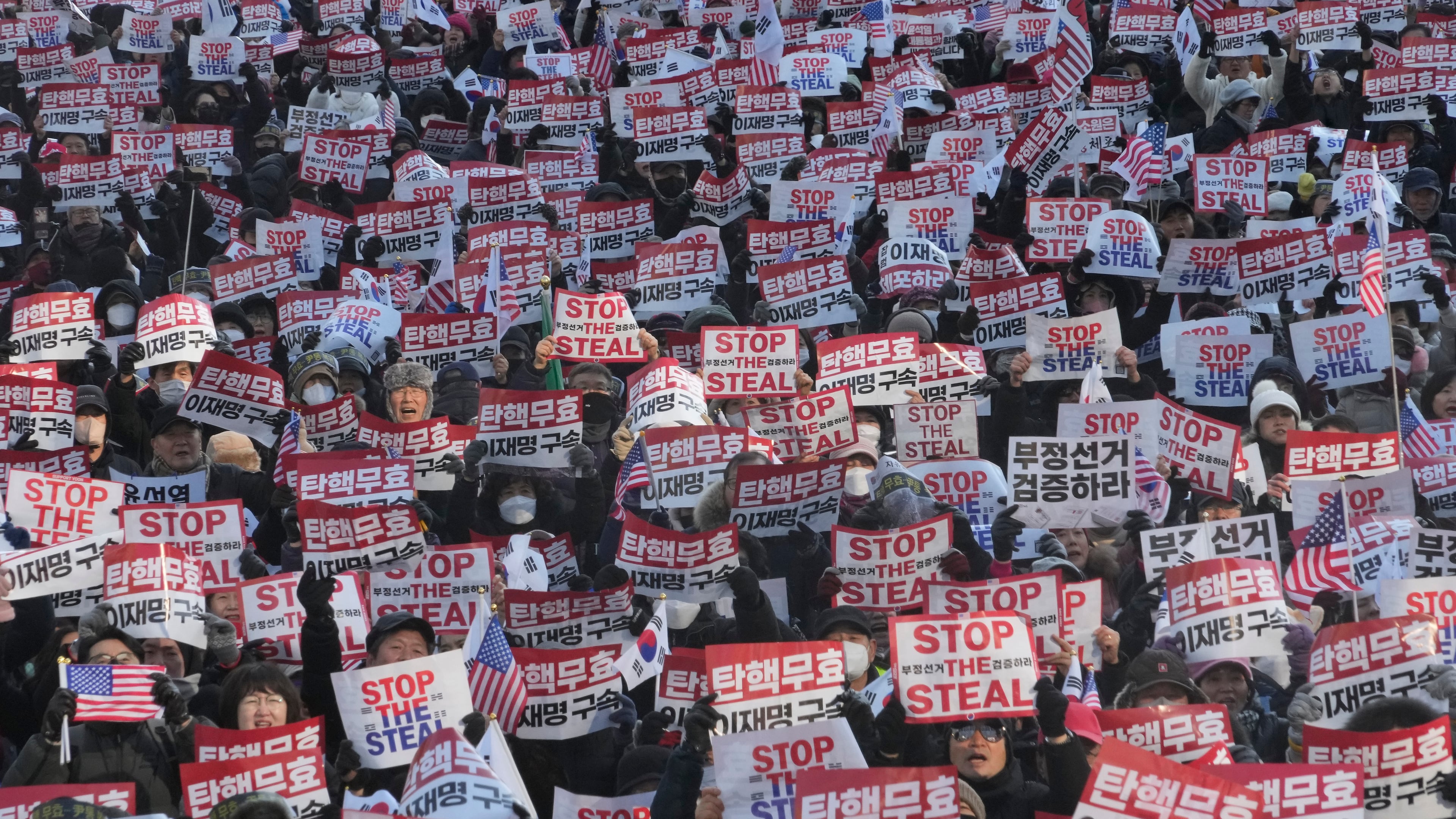 FILE- Supporters of impeached South Korean President Yoon Suk Yeol stage a rally to oppose his impeachment in Seoul, South Korea, Jan. 11, 2025. The letters read, "Impeachment is invalid." (AP Photo/Ahn Young-joon, File)
