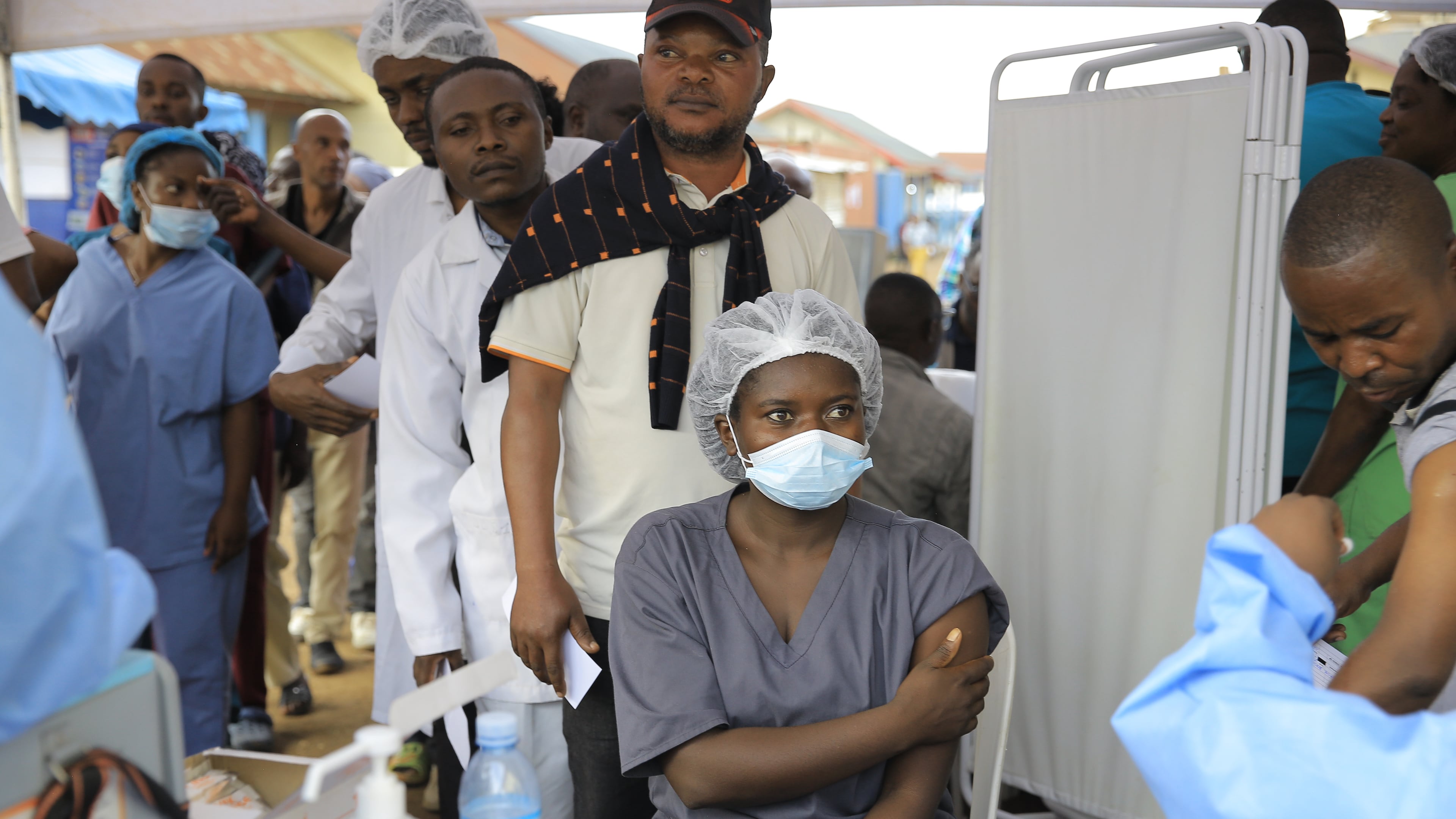 Health care workers queue to receive a dose of Ervebo vaccine against the Ebola virus in Beni, North Kivu province, eastern Congo, Friday, Oct. 16, 2026. (AP Photo/Sebastien Kitsa Musayi)