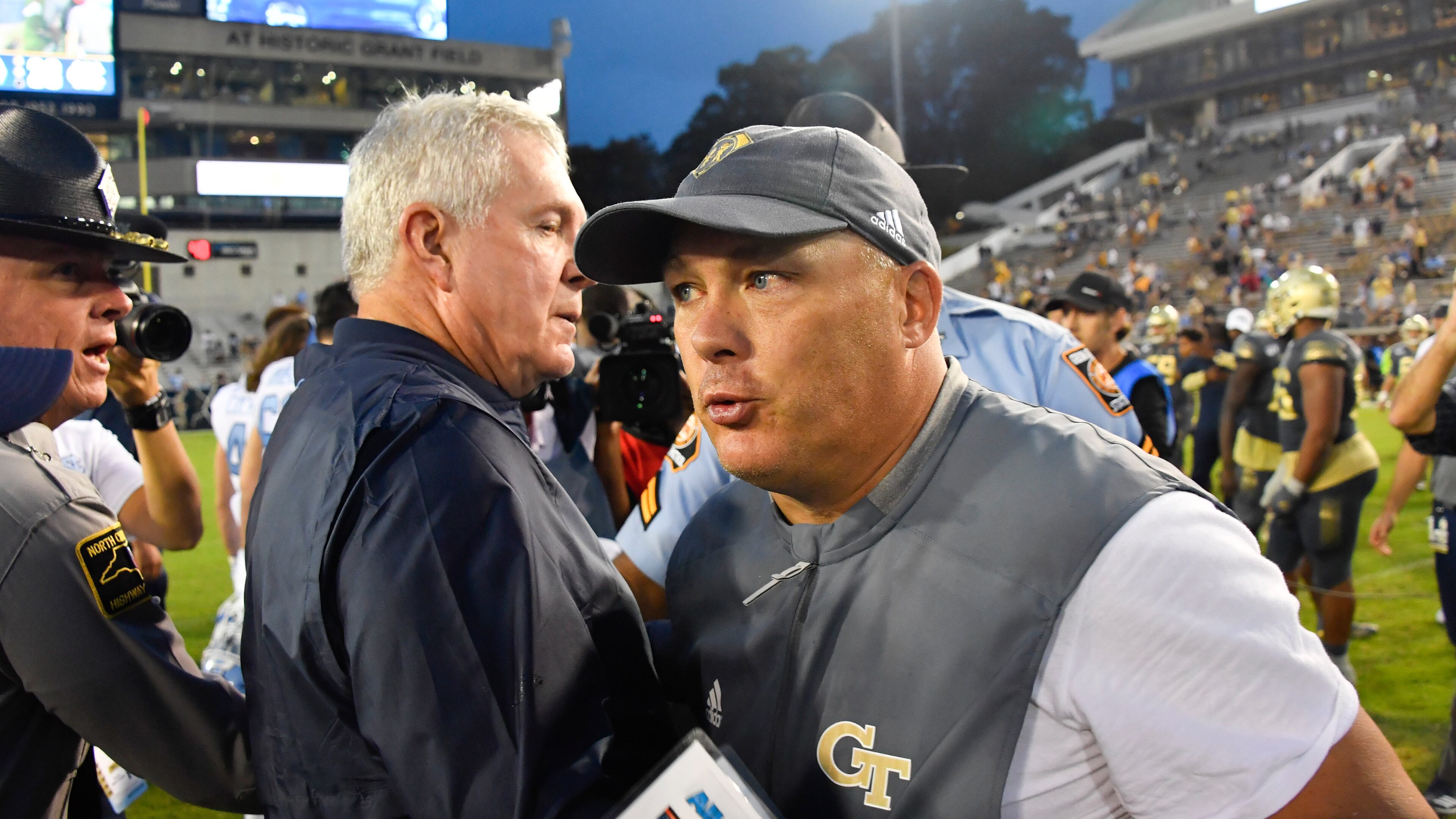 Georgia Tech coach Geoff Collins, right, and North Carolina coach Mack Brown meet up after a game against North Carolina, Saturday, Oct. 5, 2019, in Atlanta. North Carolina won 38-22. (John Amis/Special to the AJC)