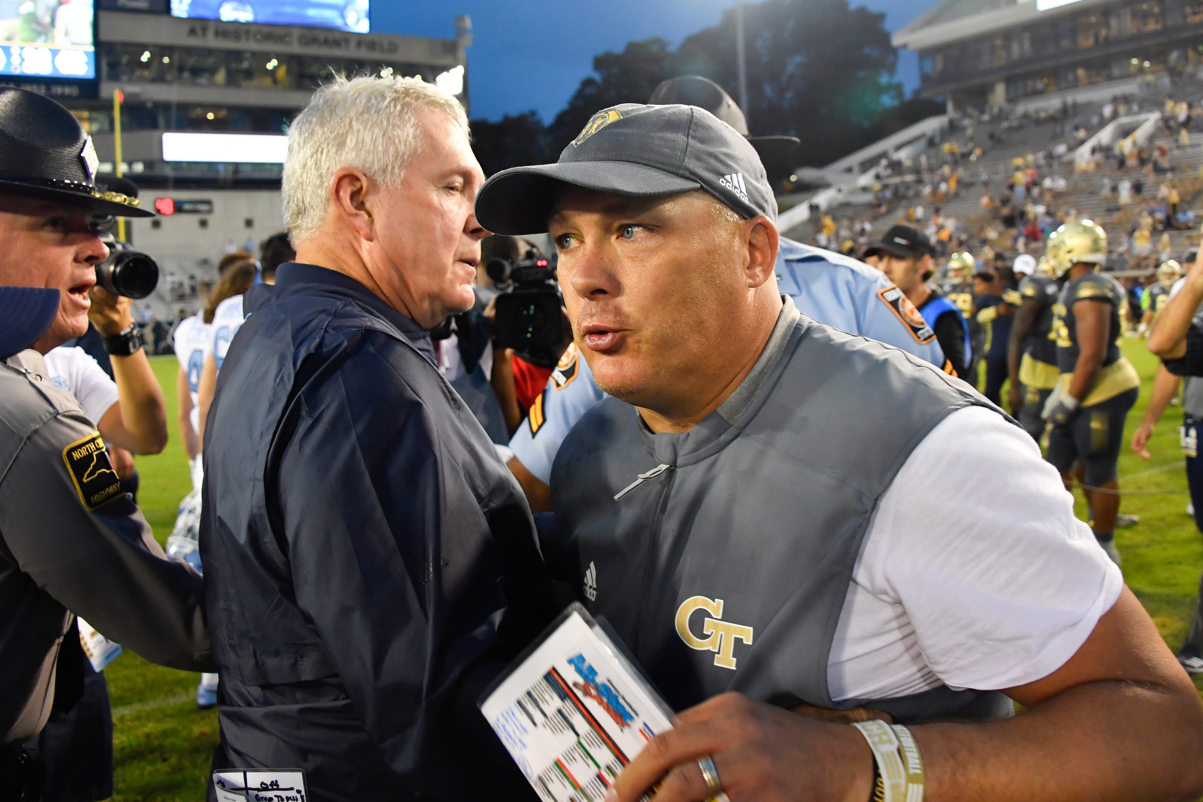Georgia Tech head coach Geoff Collins, right, and North Carolina head coach Mack Brown meet up after an NCAA college football game against North Carolina, Saturday, Oct. 5, 2019, in Atlanta. North Carolina won 38-22. (Special-John Amis)