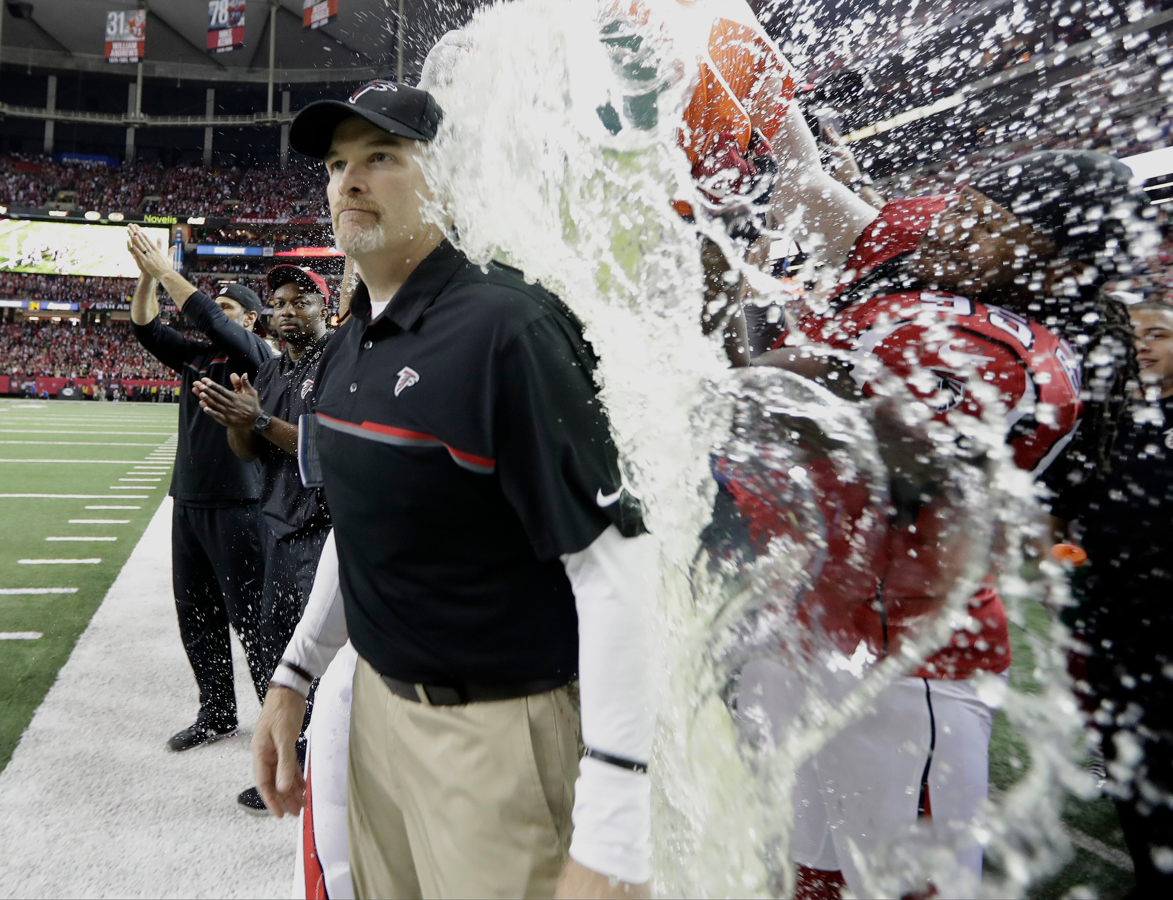 Atlanta Falcons head coach Dan Quinn is dunked during the second half of the NFL football NFC championship game against the Green Bay Packers, Sunday, Jan. 22, 2017, in Atlanta. The Falcons won 44-21 to advance to Super Bowl LI. (AP Photo/David J. Phillip)