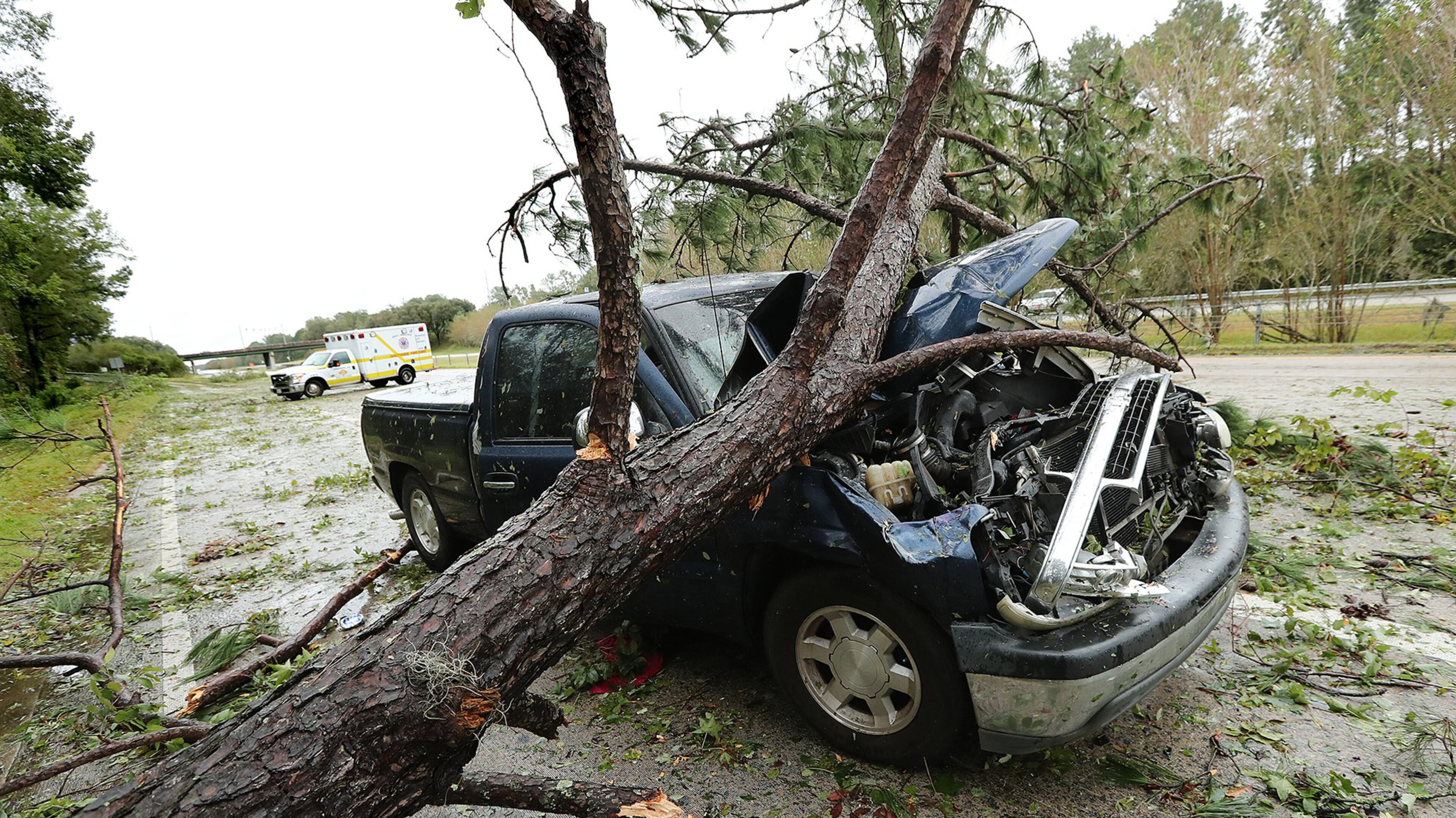 October 08, 2016 SAVANNAH: An ambulance responding to a call passes by a truck destoyed when it apparently collided with a downed tree on I-16 West during Hurricane Matthew on Saturday, Oct. 8, 2016, in Savannah. Curtis Compton /ccompton@ajc.com