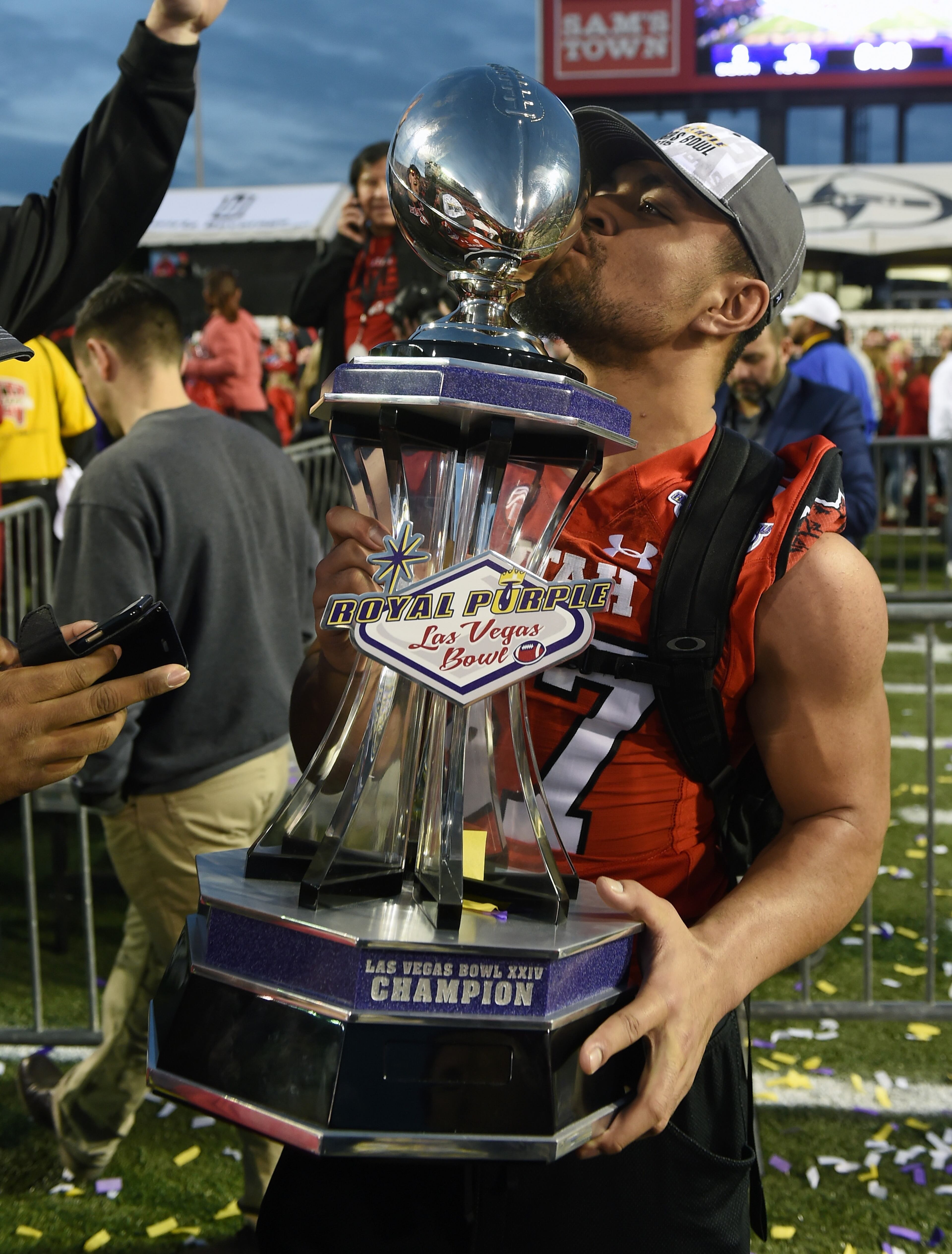 LAS VEGAS, NV - DECEMBER 19: Linebacker Justin Tatola #57 of the Utah Utes kisses the championship trophy after the Utes defeated the Brigham Young Cougars 35-28 to win the Royal Purple Las Vegas Bowl at Sam Boyd Stadium on December 19, 2015 in Las Vegas, Nevada. (Photo by Ethan Miller/Getty Images)