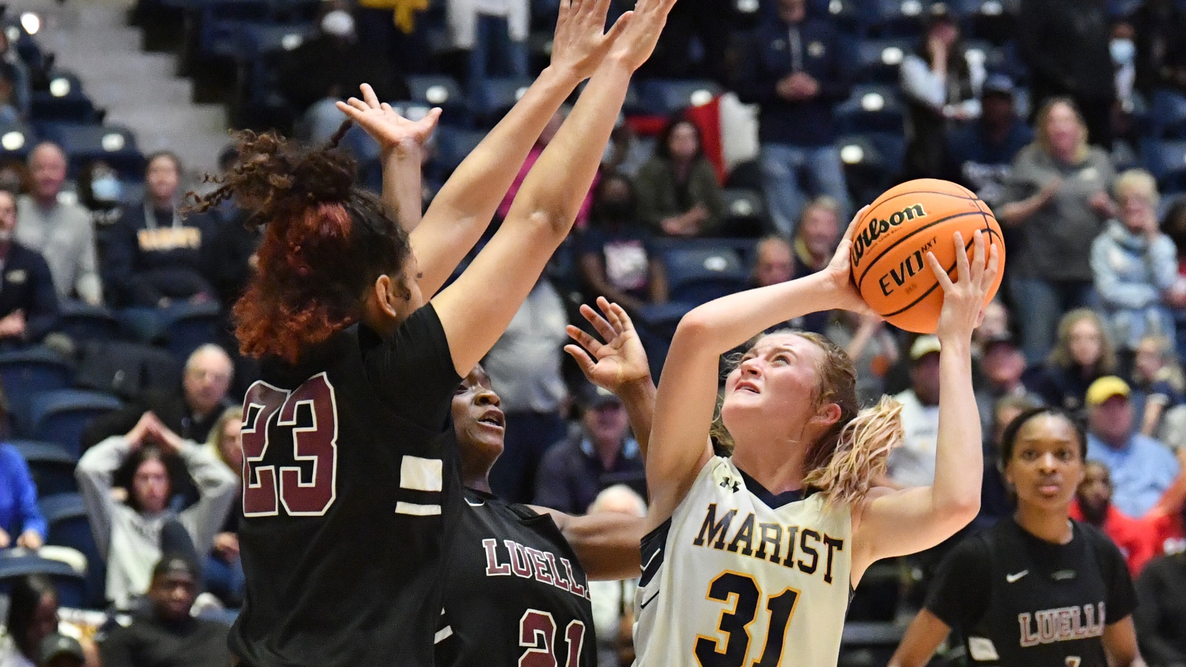 March 9, 2022 Macon - Marist's Alex Norris (31) prepares to shoot over Luella's Arianna Dyson (23) and Luella's Trinity Layton (21) in the first overtime during the 2022 GHSA State Basketball Championship game at the Macon Centreplex in Macon on Wednesday, March 9, 2022. Marist won 56-54 over Luella in overtime. (Hyosub Shin / Hyosub.Shin@ajc.com)