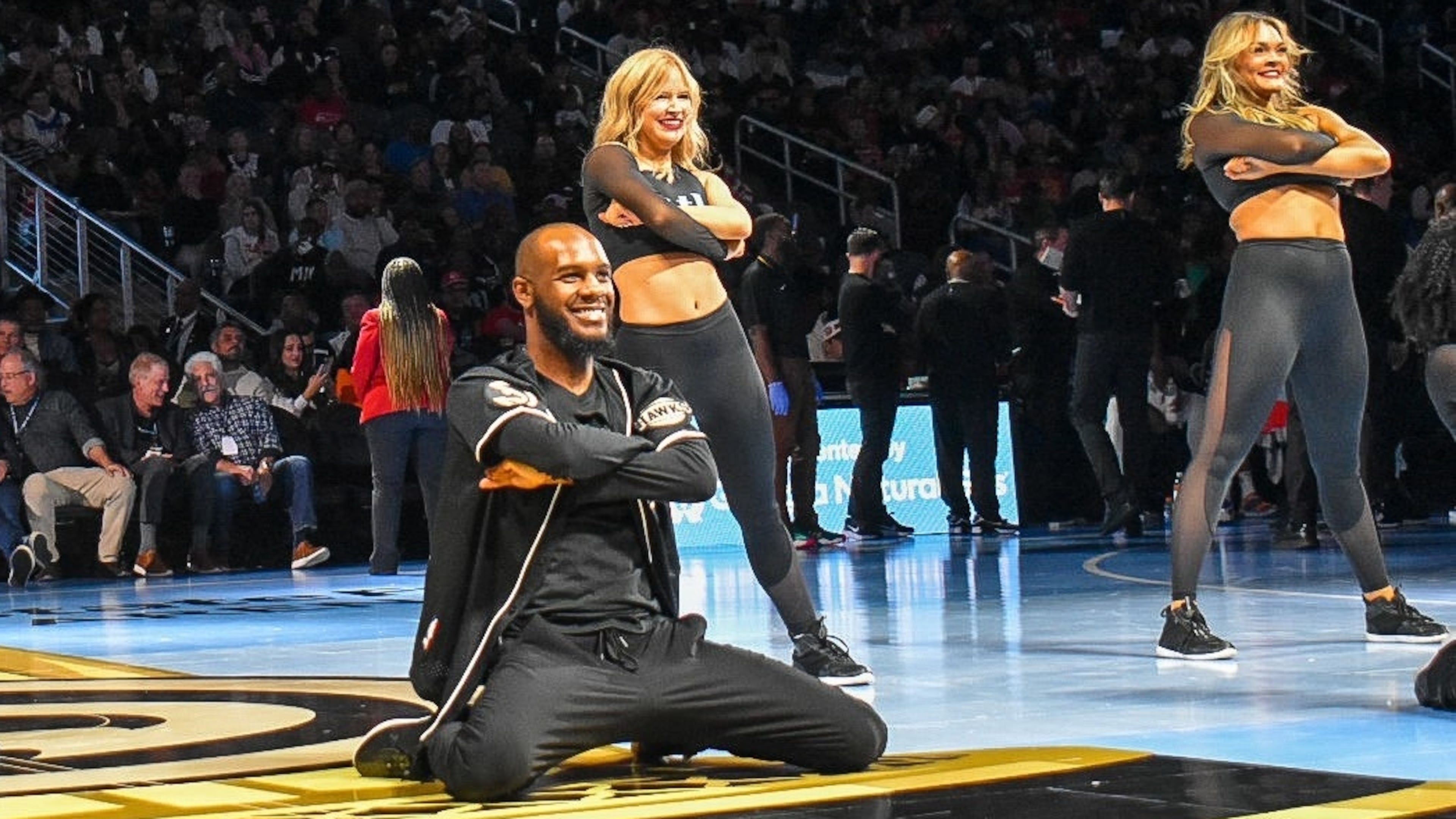 Calvin Brown (center) and fellow ATL Dancers perform at an Atlanta Hawks game. He's been with the dance team since 2021, and is preparing to pursue other career goals. (Courtesy of Atlanta Hawks)