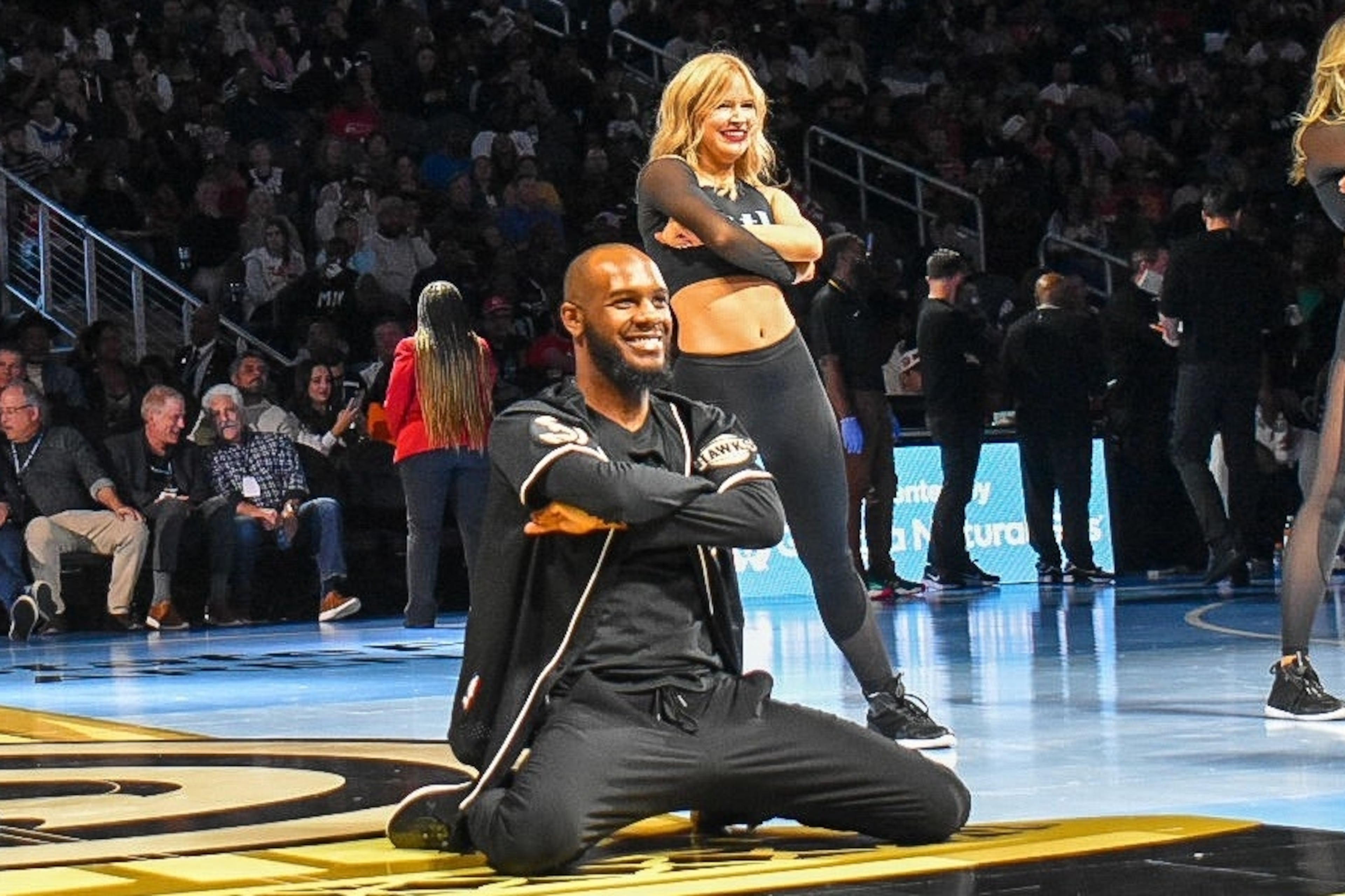 Calvin Brown (center) and fellow ATL Dancers perform at an Atlanta Hawks game. He's been with the dance team since 2021, and is preparing to pursue other career goals. (Courtesy of Atlanta Hawks)