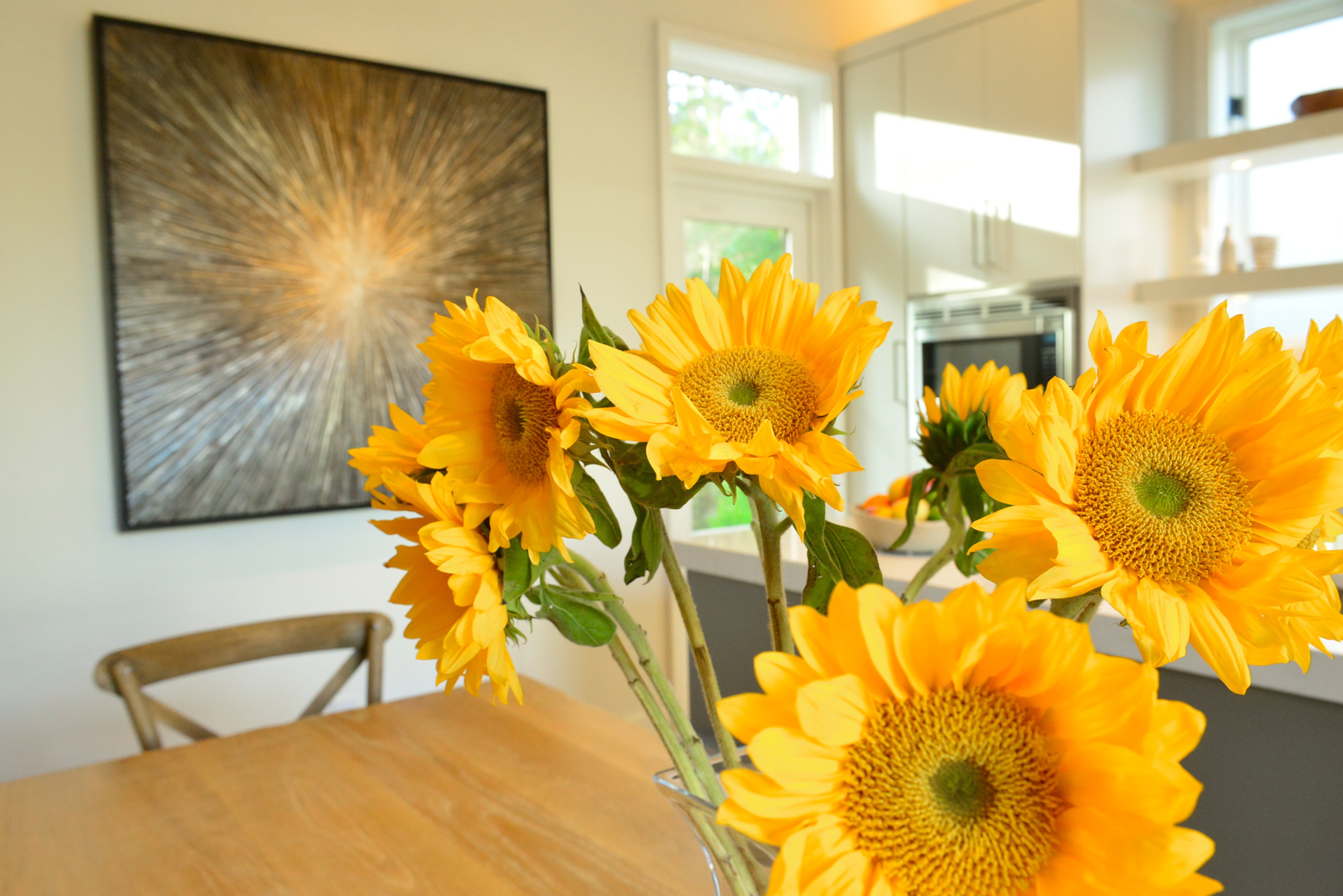 A farm table from Bungalow Classic in Atlanta sits right off the kitchen island and serves as the center of the house.