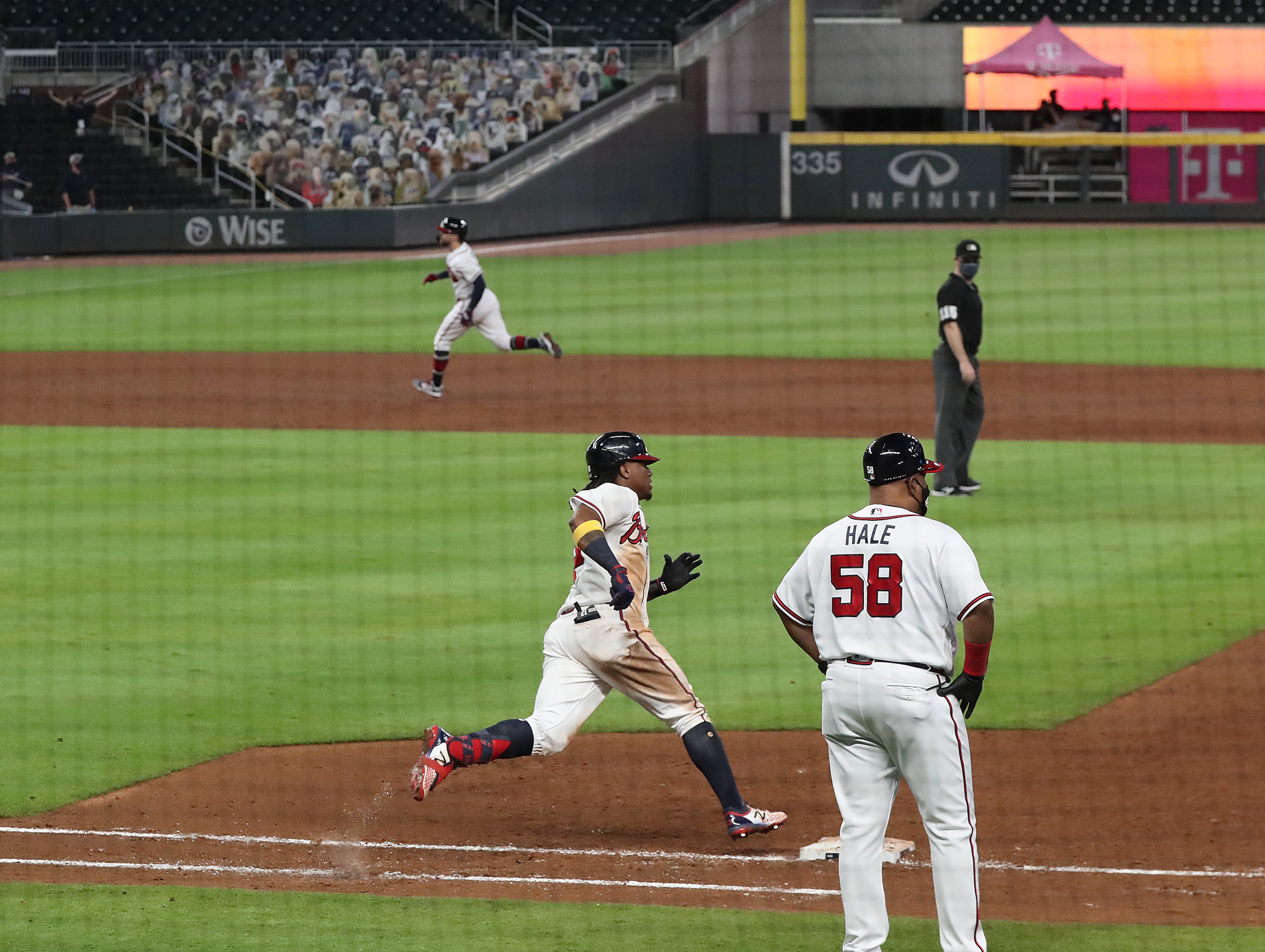 Atlanta Braves' Ronald Acuna rounds first hitting a 3-RBI double while Ender Inciarte heads home to take a 25-8 lead over the Miami Marlins during the sixth inning and set a new franchise scoring record in a MLB baseball game on Wednesday, Sept. 9, 2020 in Atlanta. “Curtis Compton / Curtis.Compton@ajc.com”