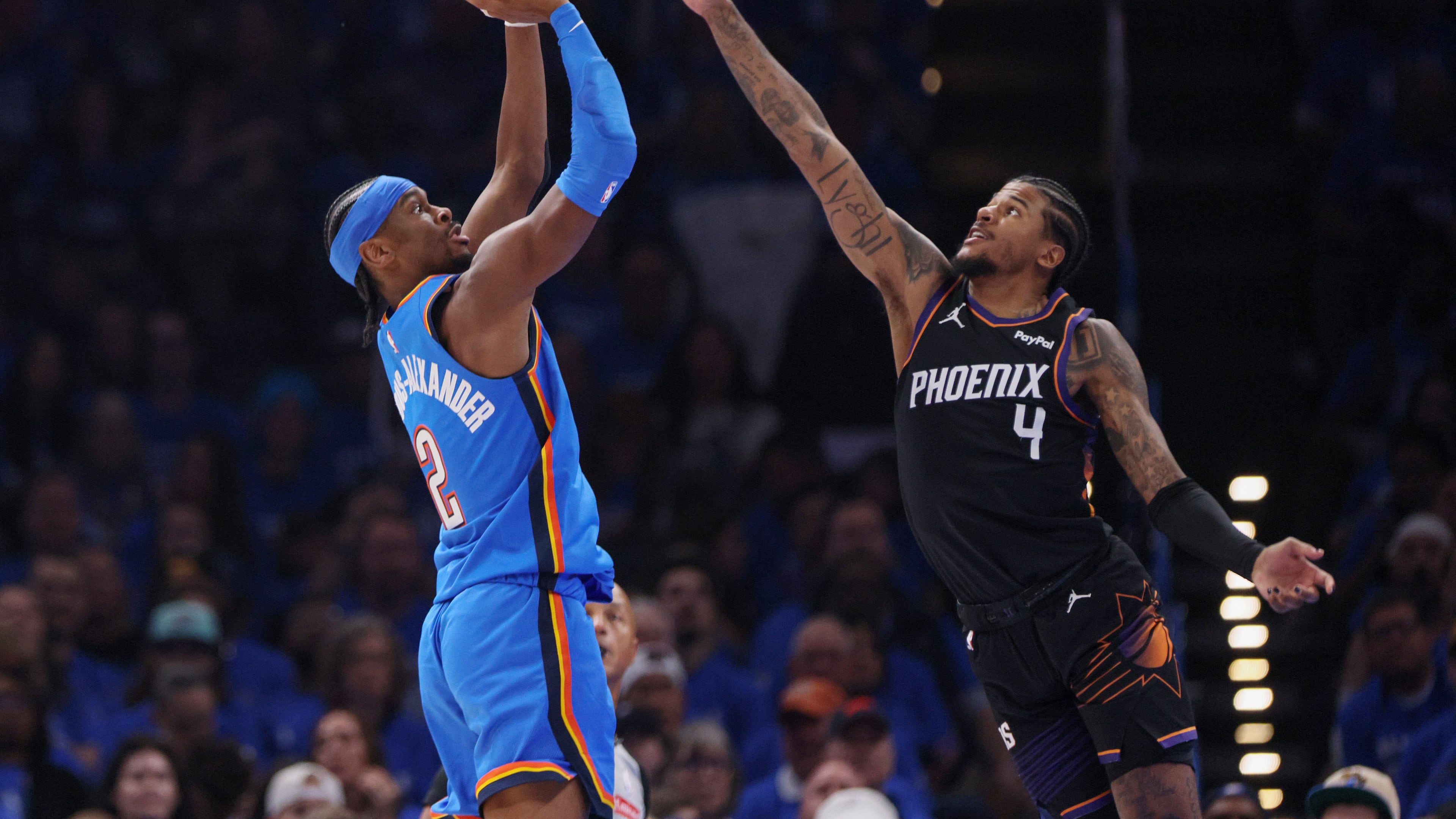 Oklahoma City Thunder guard Shai Gilgeous-Alexander (2) looks to shoot over Phoenix Suns guard Jalen Green (4) during the first half in Game 1 of a first-round NBA playoffs basketball series Sunday, April 19, 2026, in Oklahoma City. (AP Photo/Nate Billings)