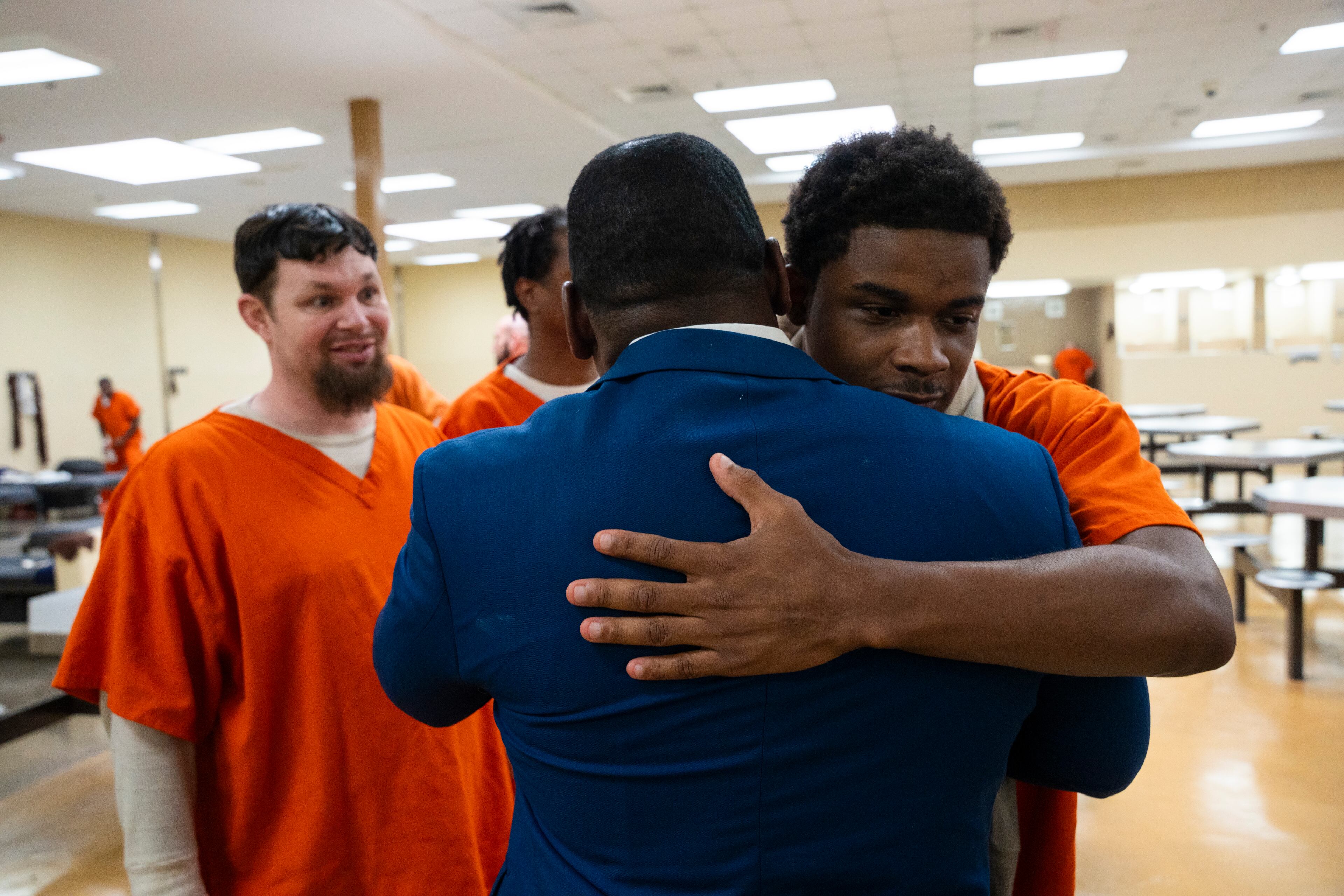 Danrius Hendricks hugs Shane Sims after class in the Athens-Clarke County Jail. Hendricks acknowledges the program has forced him to face parts of himself he’d buried behind bravado. (Olivia Bowdoin for the AJC)