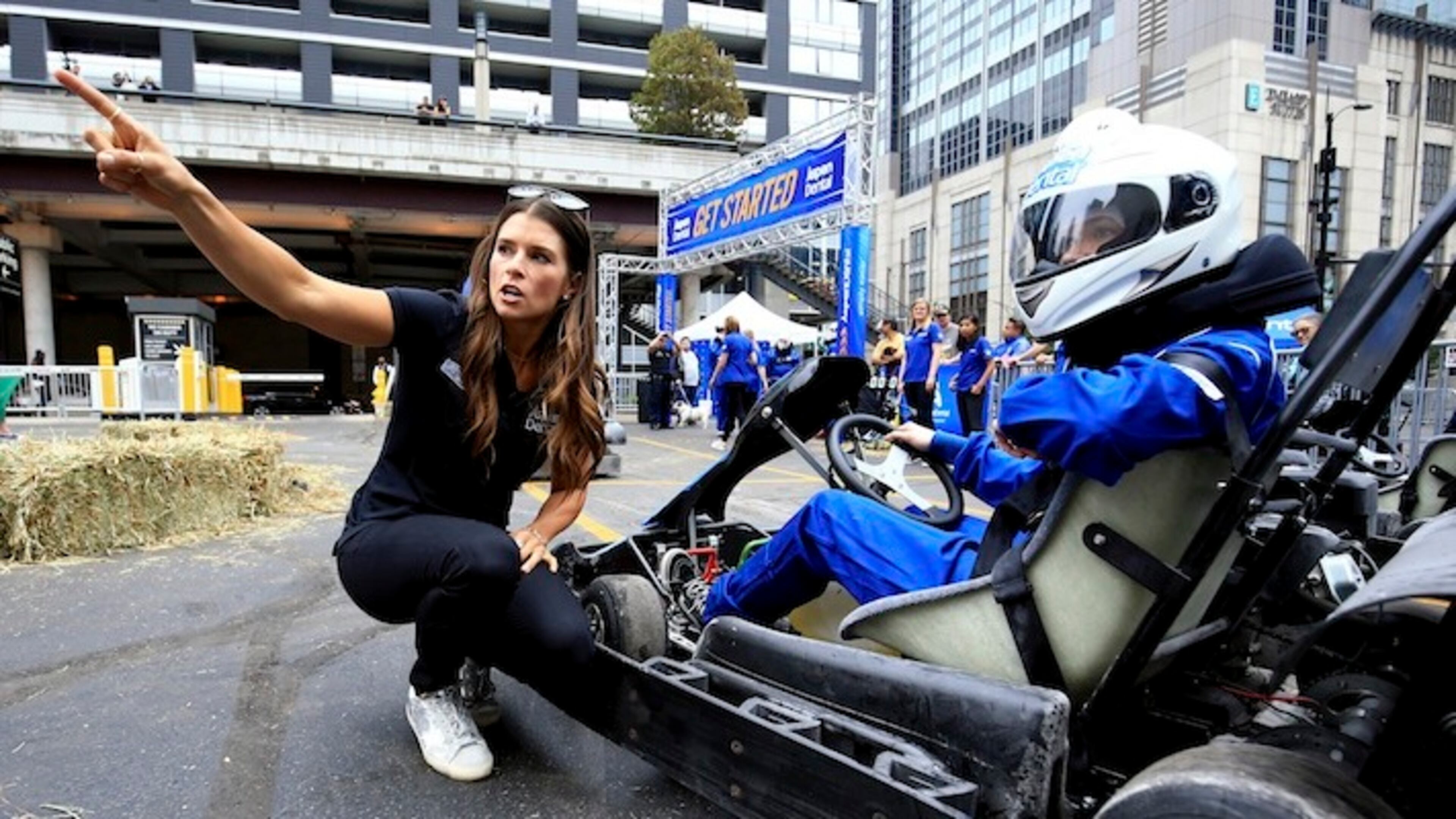 IMAGE DISTRIBUTED FOR ASPEN DENTAL - Danica Patrick gives driving tips to fans at the Aspen Dental molar-shaped pop-up go kart track on Wednesday, Sept. 13, 2017 in Chicago. The event was organized in advance of Sunday's NASCAR race at Chicagoland Speedway to show fans how easy it is to navigate around barriers to dental care on the road to a healthy mouth. (Andrew Weber/AP Images for Aspen Dental)