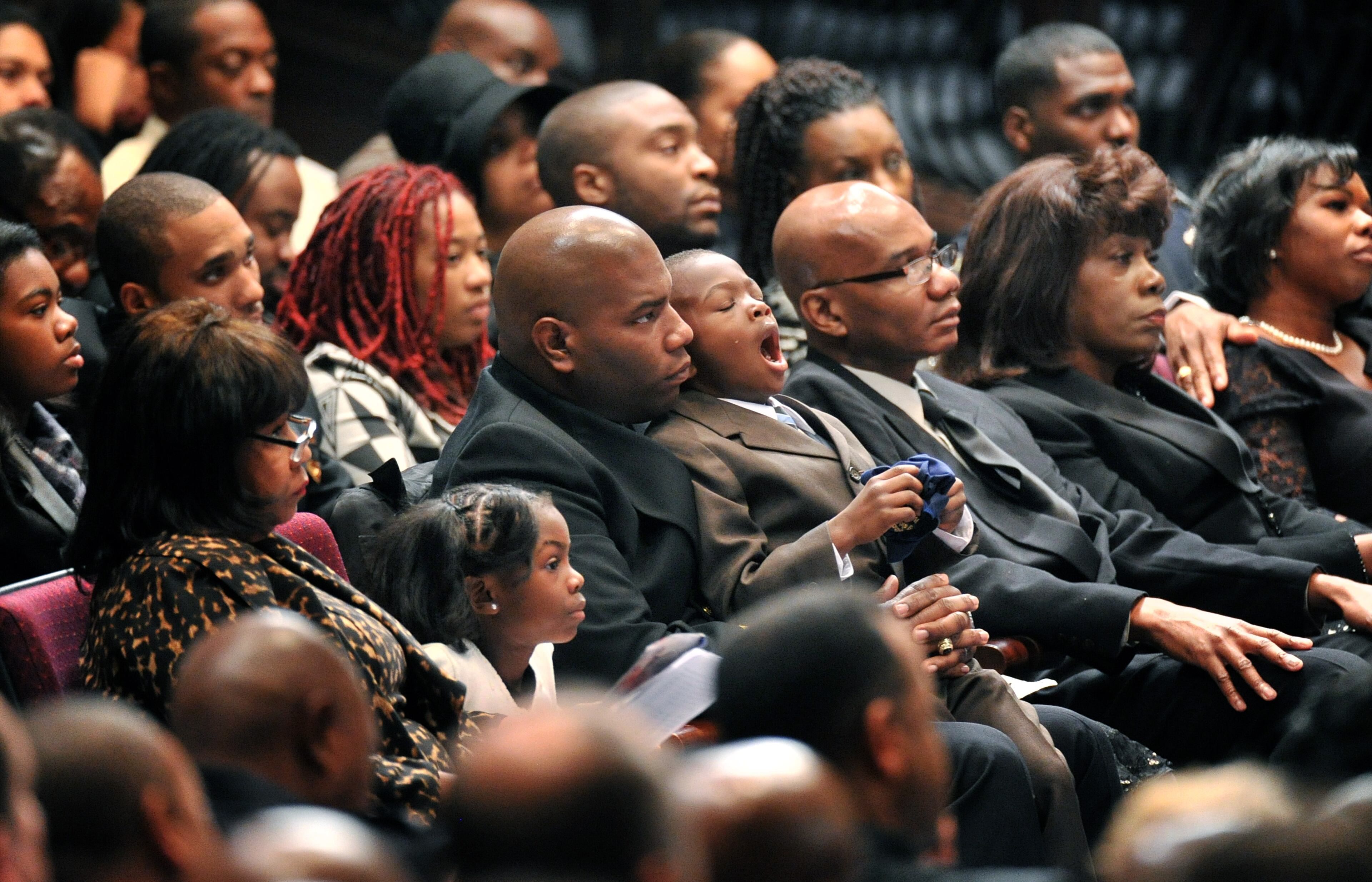 APD Officer Shawn Smiley's best friend Joshua Sanders (center) holds Shawn Smiley's son William Smiley as he yawns during APD Officer Shawn Smiley's funeral at First Baptist Church of Atlanta on Saturday, November 10, 2012. APD Officer Shawn Smiley was in the passenger seat last weekend when an APD helicopter searching for a missing 9-year-old boy crashed in Atlanta. HYOSUB SHIN / HSHIN@AJC.COM