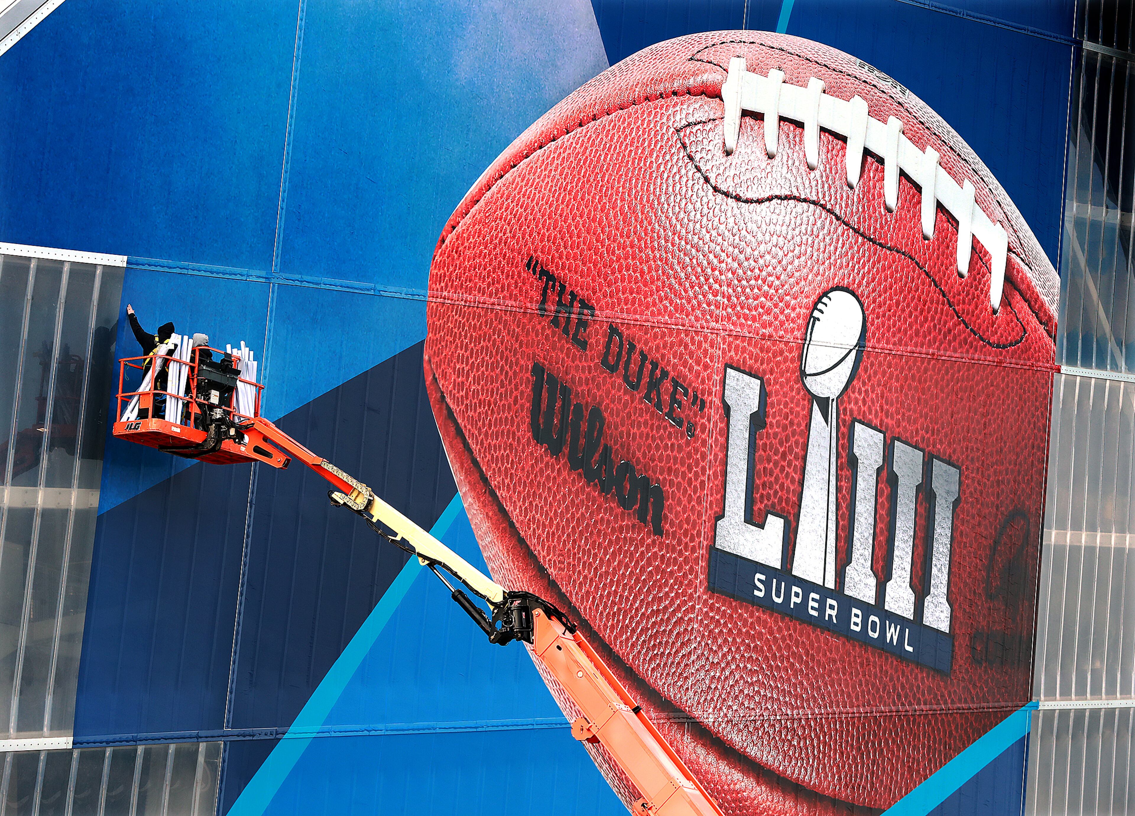 Jan. 17, 2019 Atlanta: Workers use a lift to install a Super Bowl LIII wrap on the outside of Mercedes-Benz Stadium as it is transformed for the big game on Thursday, Jan. 17, 2019, in Atlanta. Curtis Compton/ccompton@ajc.com