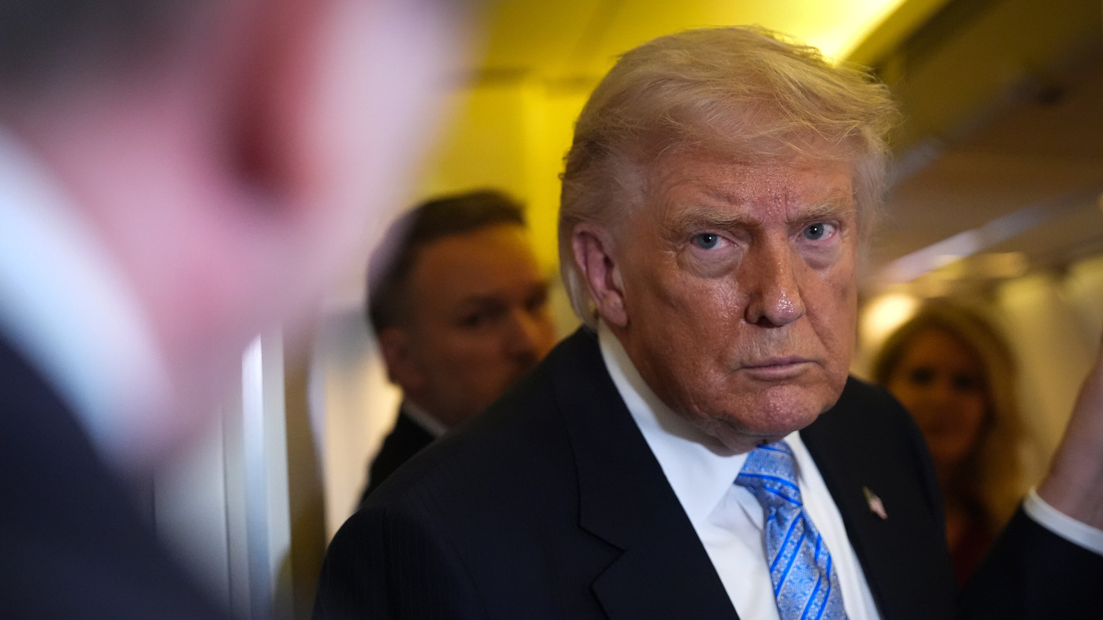 President Donald Trump speaks to reporters aboard Air Force One, Friday, May 15, 2026, as he returns from a trip to Beijing, China. (AP Photo/Mark Schiefelbein)