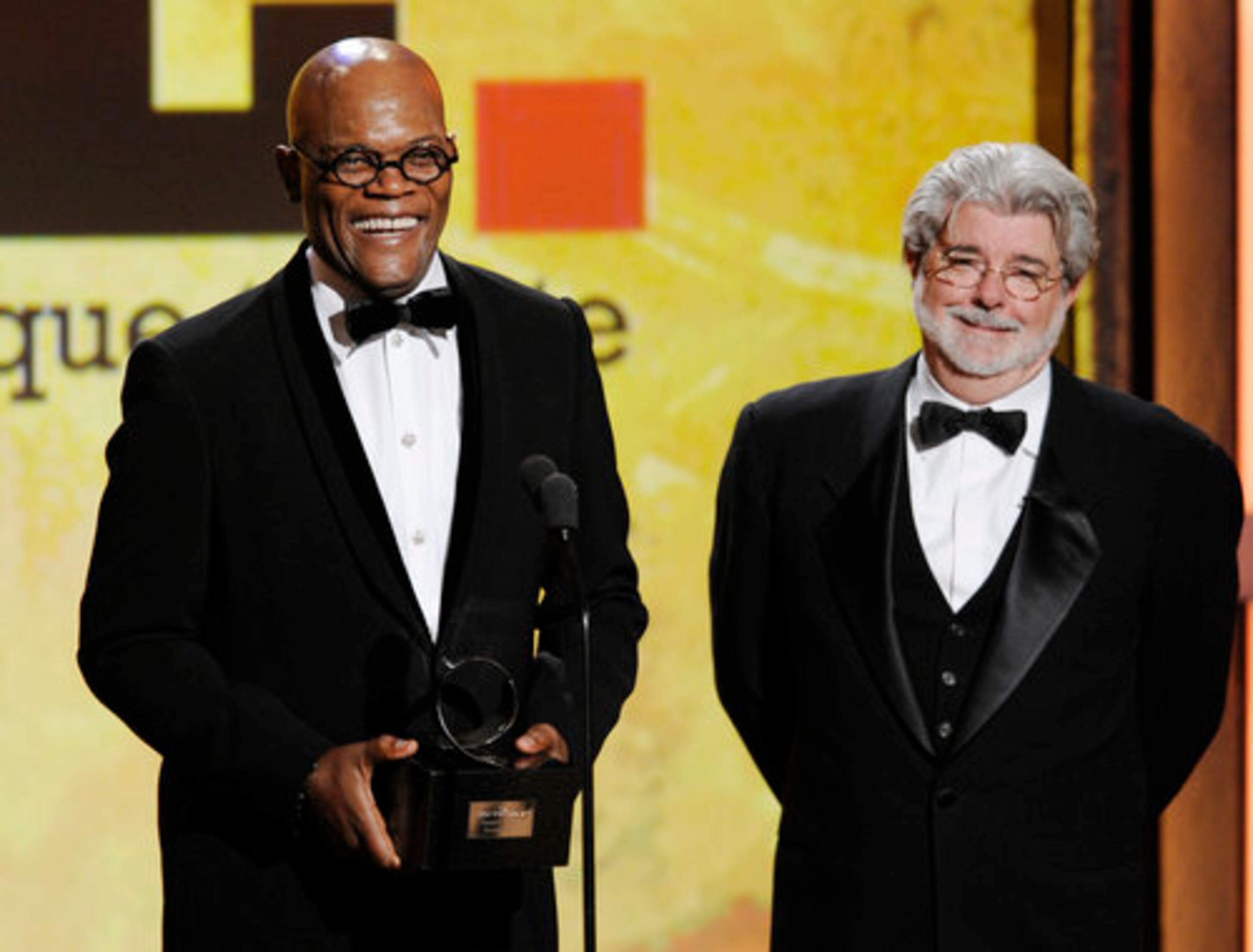 Jackson accepts the award from "Star Wars" creator George Lucas.