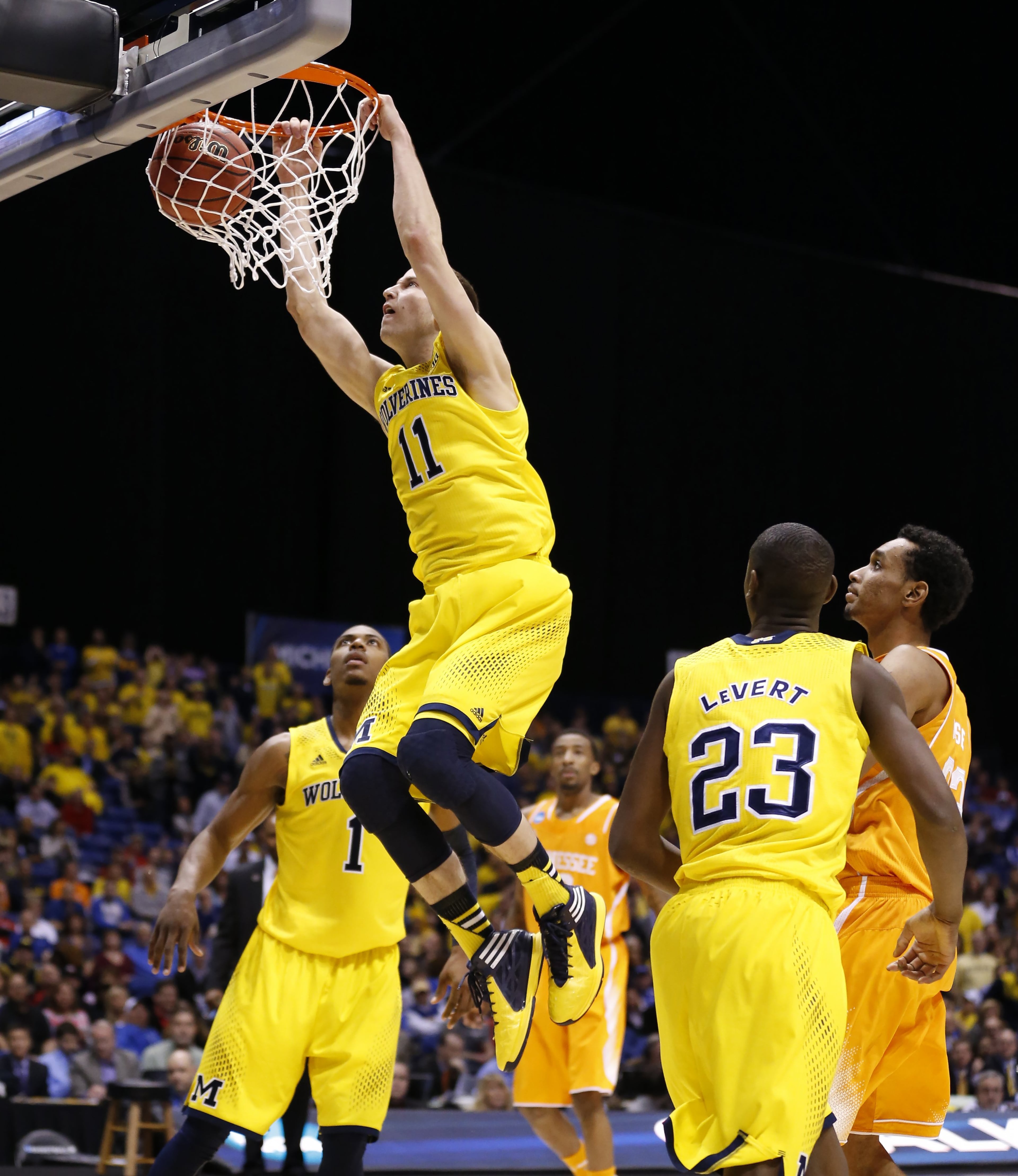 Michigan Wolverines guard Nik Stauskas (11) slams home this first half dunk. Tennessee takes on Michigan in the Midwest Regional Friday, Mar. 28, 2014, in Indianapolis.