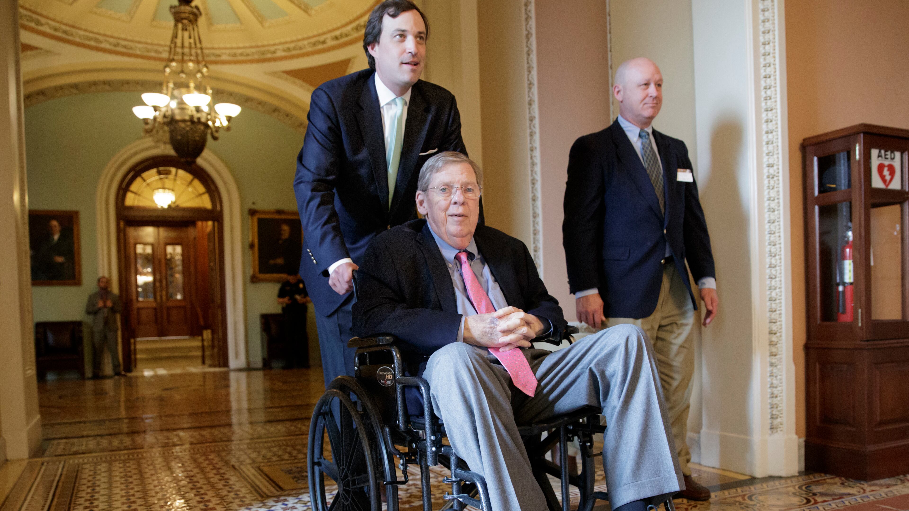Sen. Johnny Isakson, R-Ga., who is recovering from back surgery, is wheeled away from the Senate chamber on Capitol Hill in Washington, Thursday, March 30, 2017, following a vote to advance legislation that would allow states to block federal family-planning funds to Planned Parenthood. (AP Photo/J. Scott Applewhite)