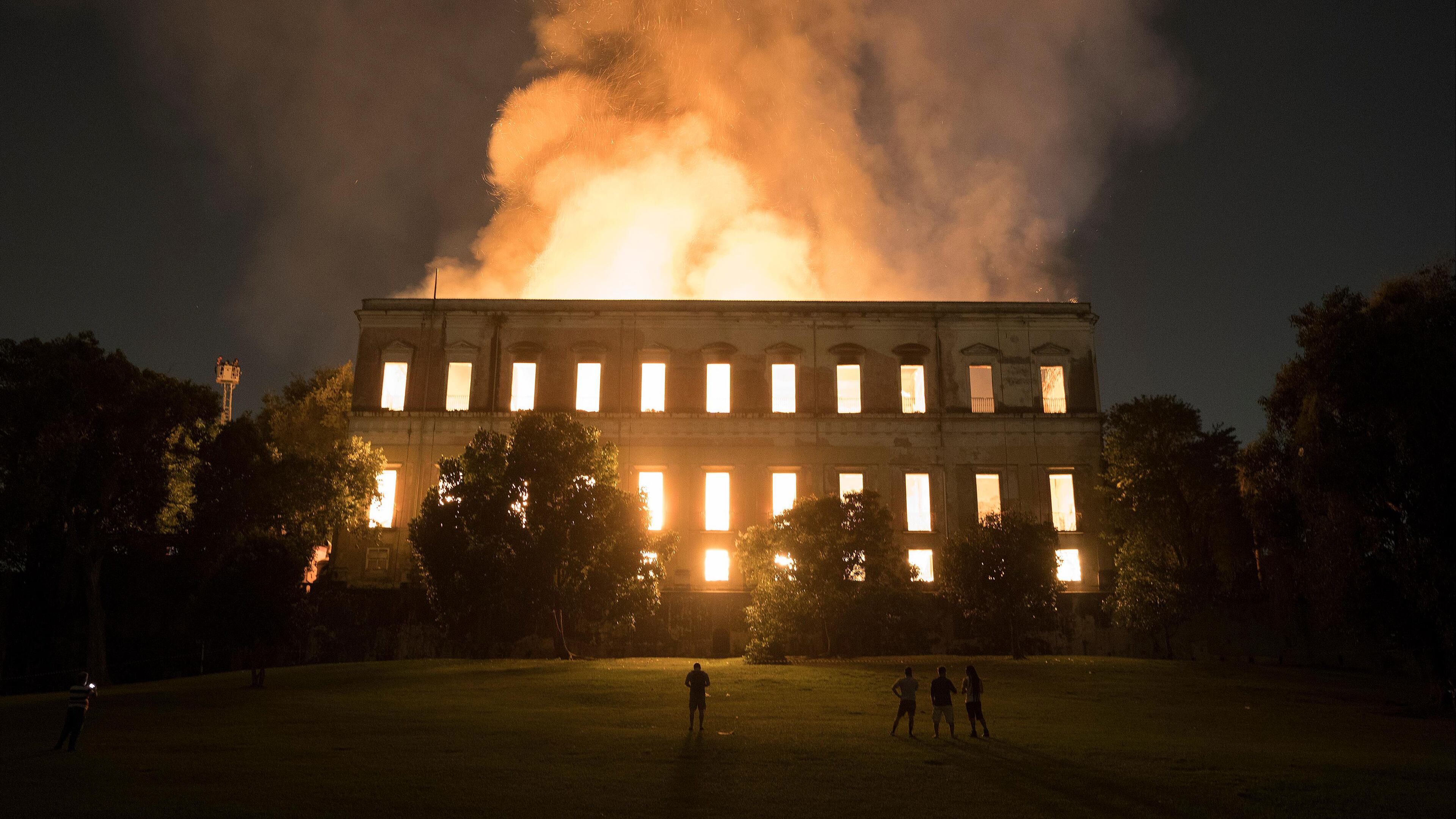 People watch as flames engulf the 200-year-old National Museum of Brazil in Rio de Janeiro on Sunday.