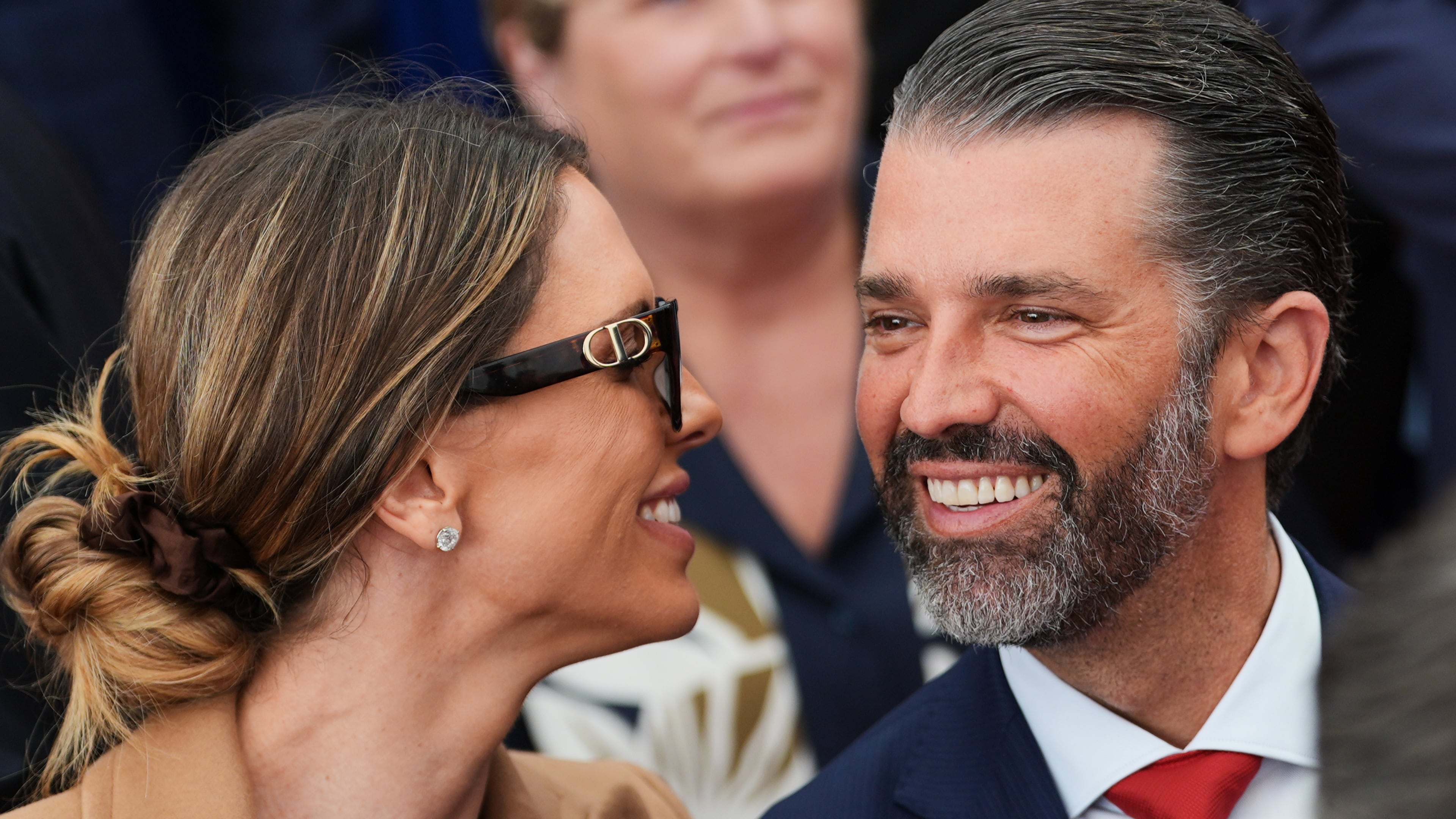 FILE - Donald Trump Jr., speaks with his wife Bettina, left, as they wait for President Donald Trump to deliver remarks to U.S. embassy staff at Deerfield Residence in Dublin, Sept. 12, 2026. (AP Photo/Julia Demaree Nikhinson, File)