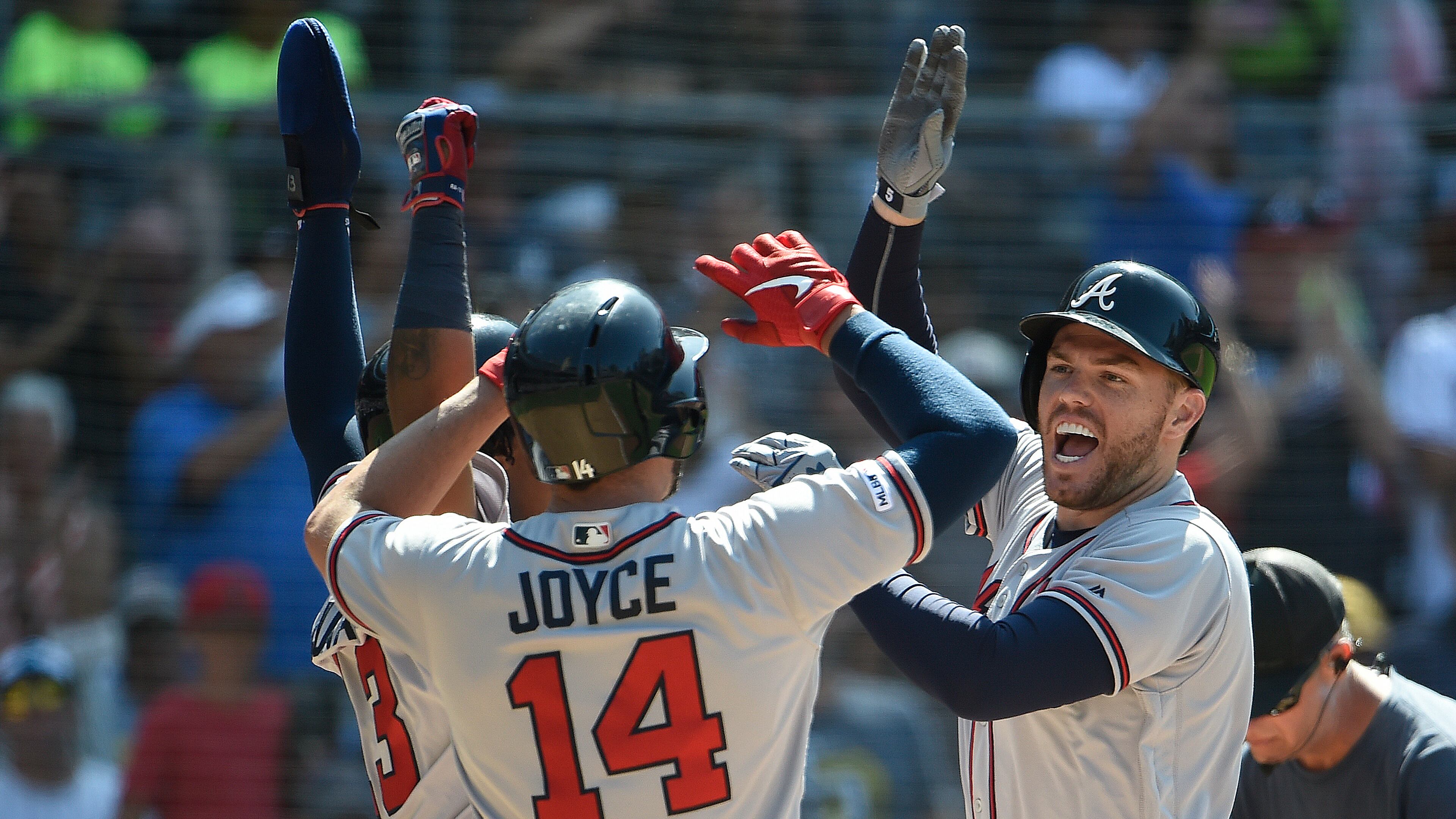 Braves' Freddie Freeman (right) is congratulated by Matt Joyce and Ronald Acuna (left) after hitting a three-run home run during the eighth inning July 14, 2019, against the San Diego Padres at Petco Park in San Diego.