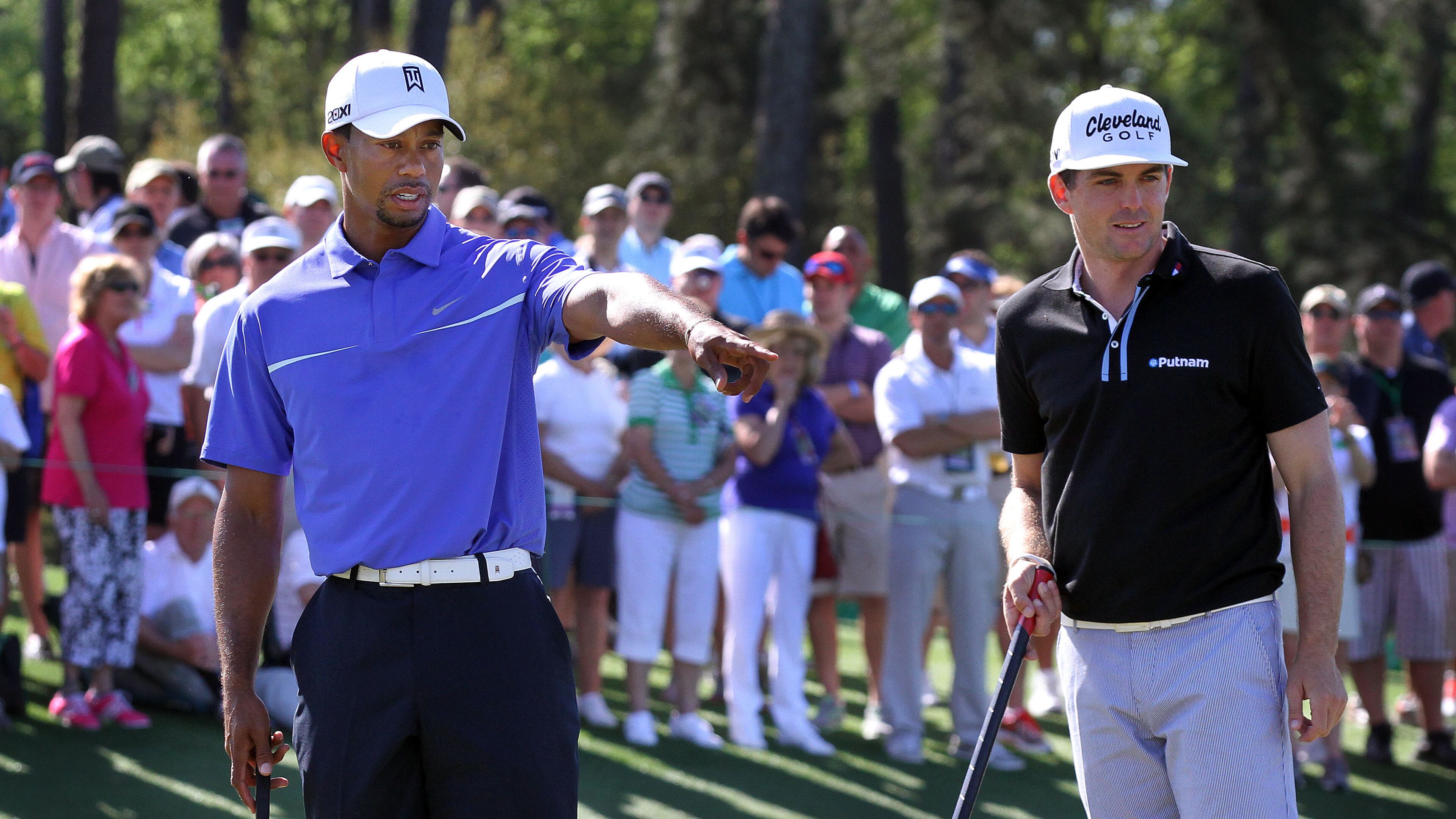 Tiger Woods (left) and Keegan Bradley talk over a shot on the 17th green during the third day of practice rounds for the Masters Tournament at Augusta National Golf Club on April 10.
