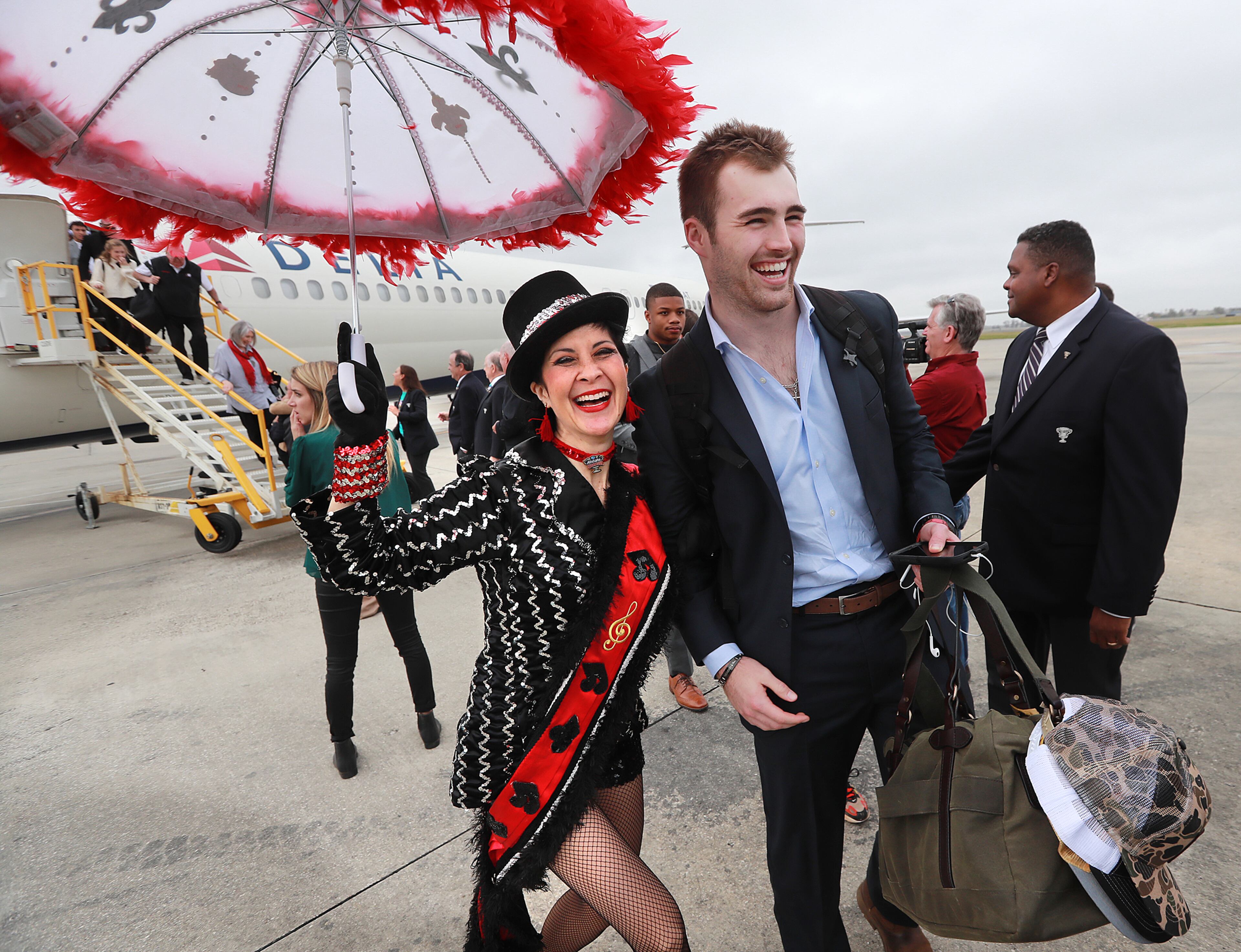 Georgia quarterback Jake Fromm is welcomed by Suzaune Yee McKamey, the grand marshall of the 3rd Line Brass Band, as the Bulldogs arrive for the Sugar Bowl at Louis Armstrong International Airport on Friday, December 27, 2019, in New Orleans. Curtis Compton/ccompton@ajc.com