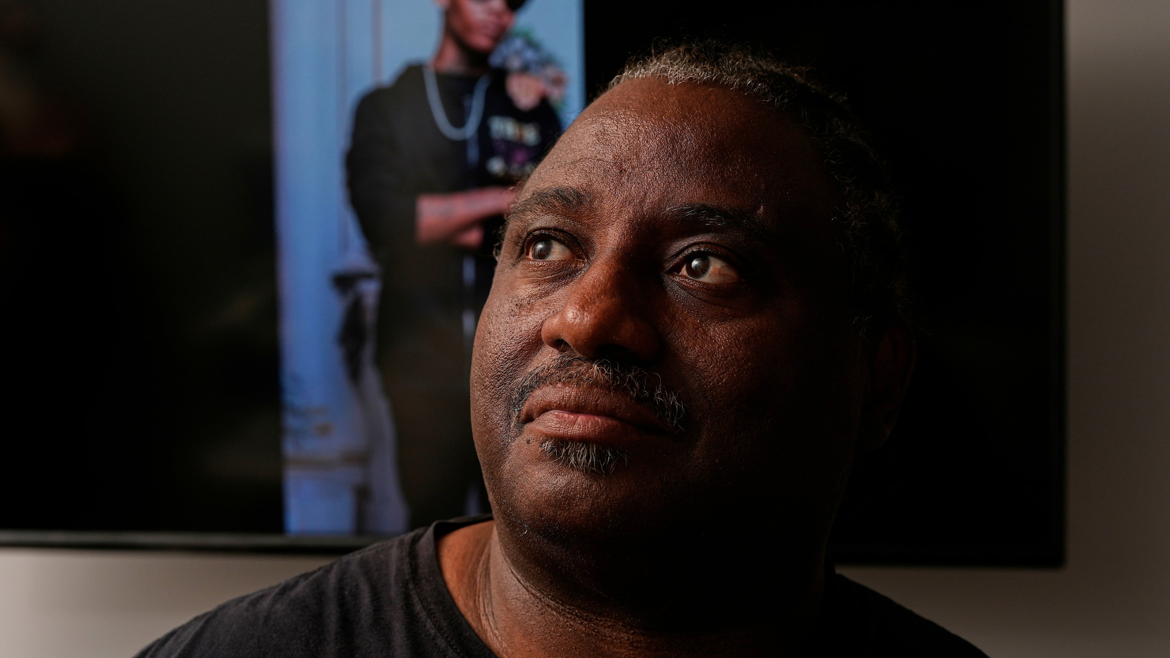 Evaniel Johnson poses with a picture of his grandson, Tyrin Johnson, Monday, July 6, 2026, in Nashville, Tenn., after his grandson was fatally shot by two Tennessee National Guard members in Memphis on Sunday, morning. (AP Photo/George Walker IV)