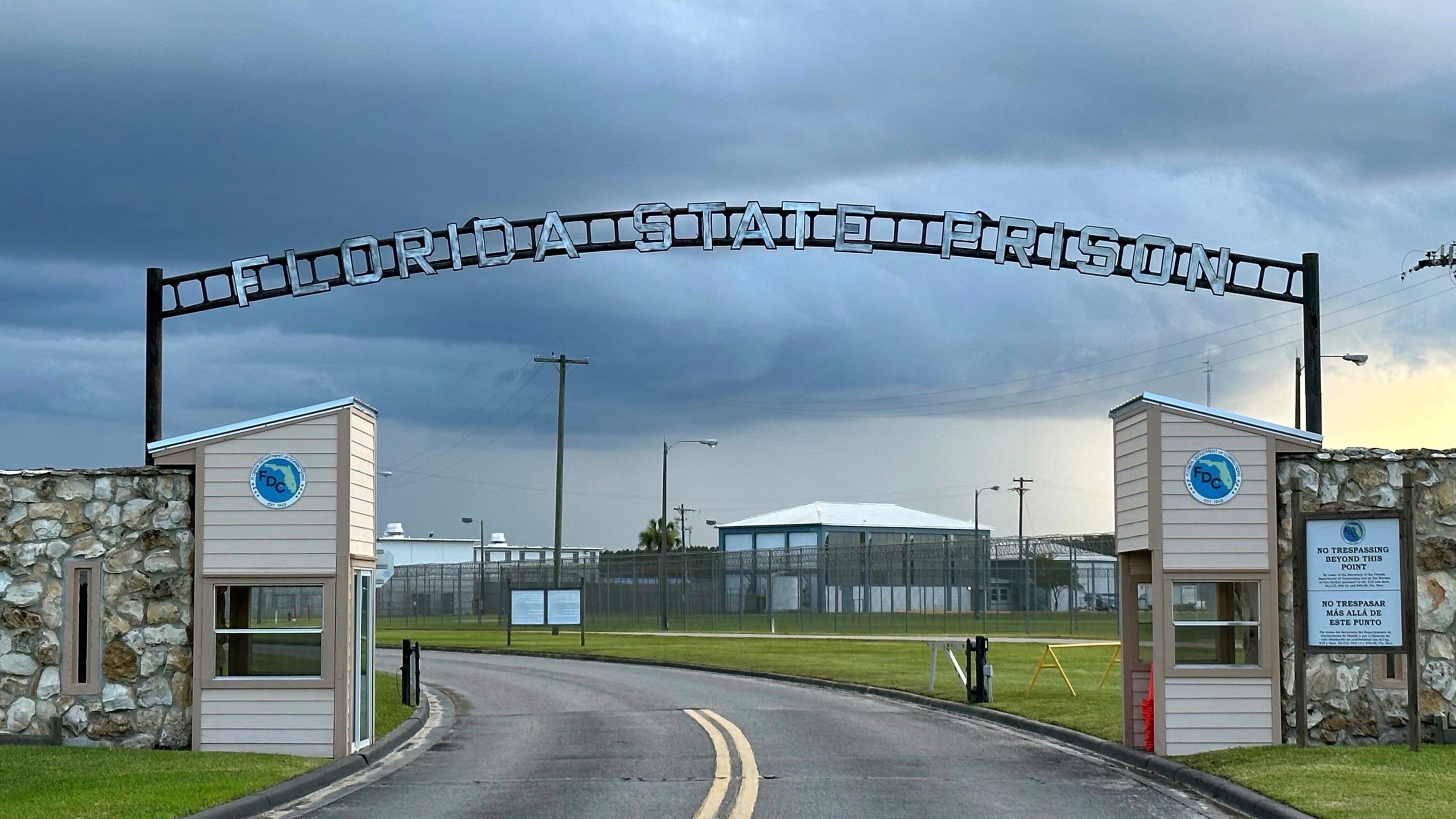 FILE - Clouds hover over the entrance of the Florida State Prison in Starke, Fla., Aug. 3, 2023. (AP Photo/Curt Anderson, File)