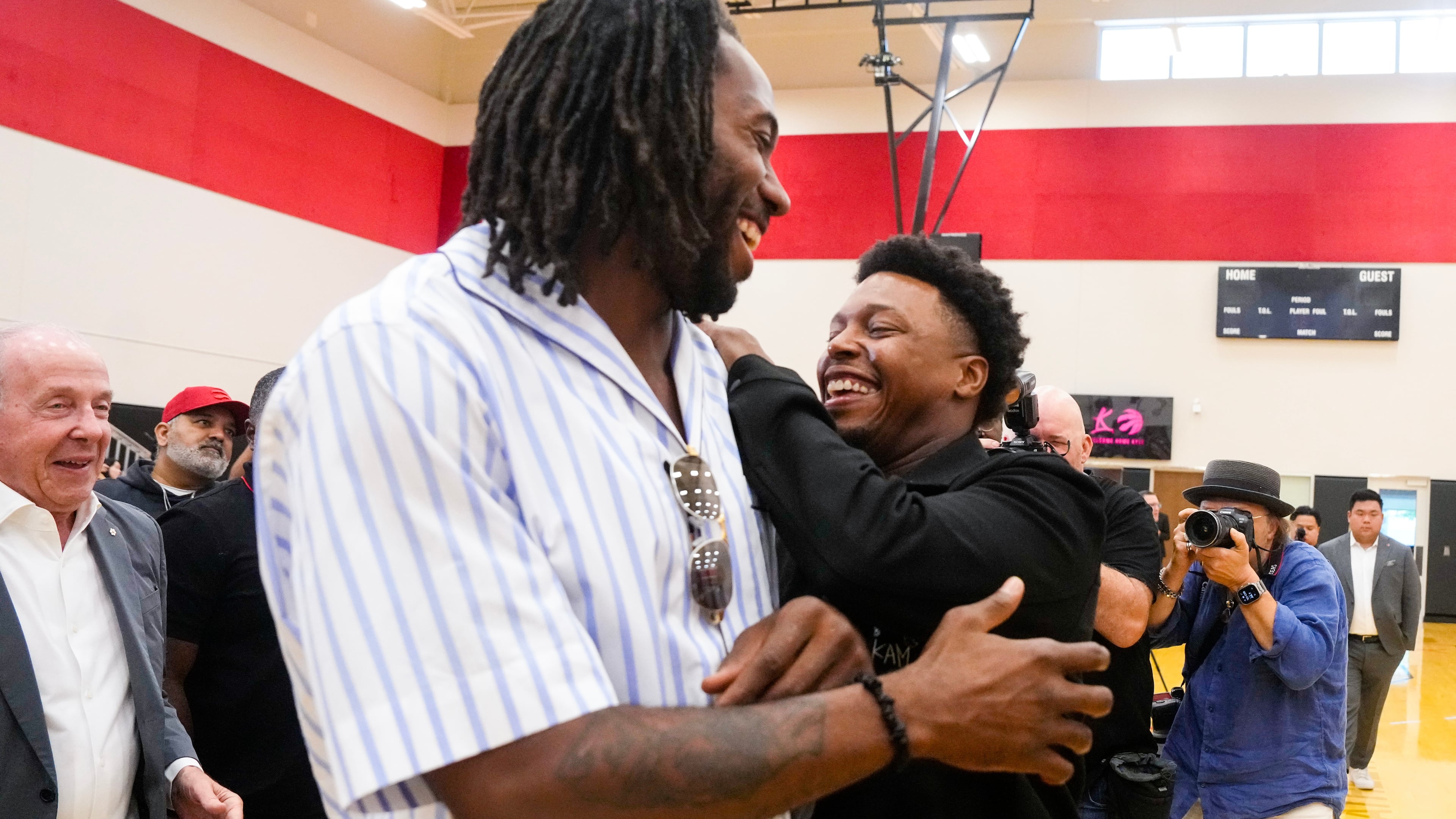 Kyle Lowry, right, speaks with Kawhi Leonard after a press conference in which Lowry signed a one-day contract to retire as a Toronto Raptor, in Toronto, on Tuesday, July 7, 2026. (Chris Young/The Canadian Press via AP)