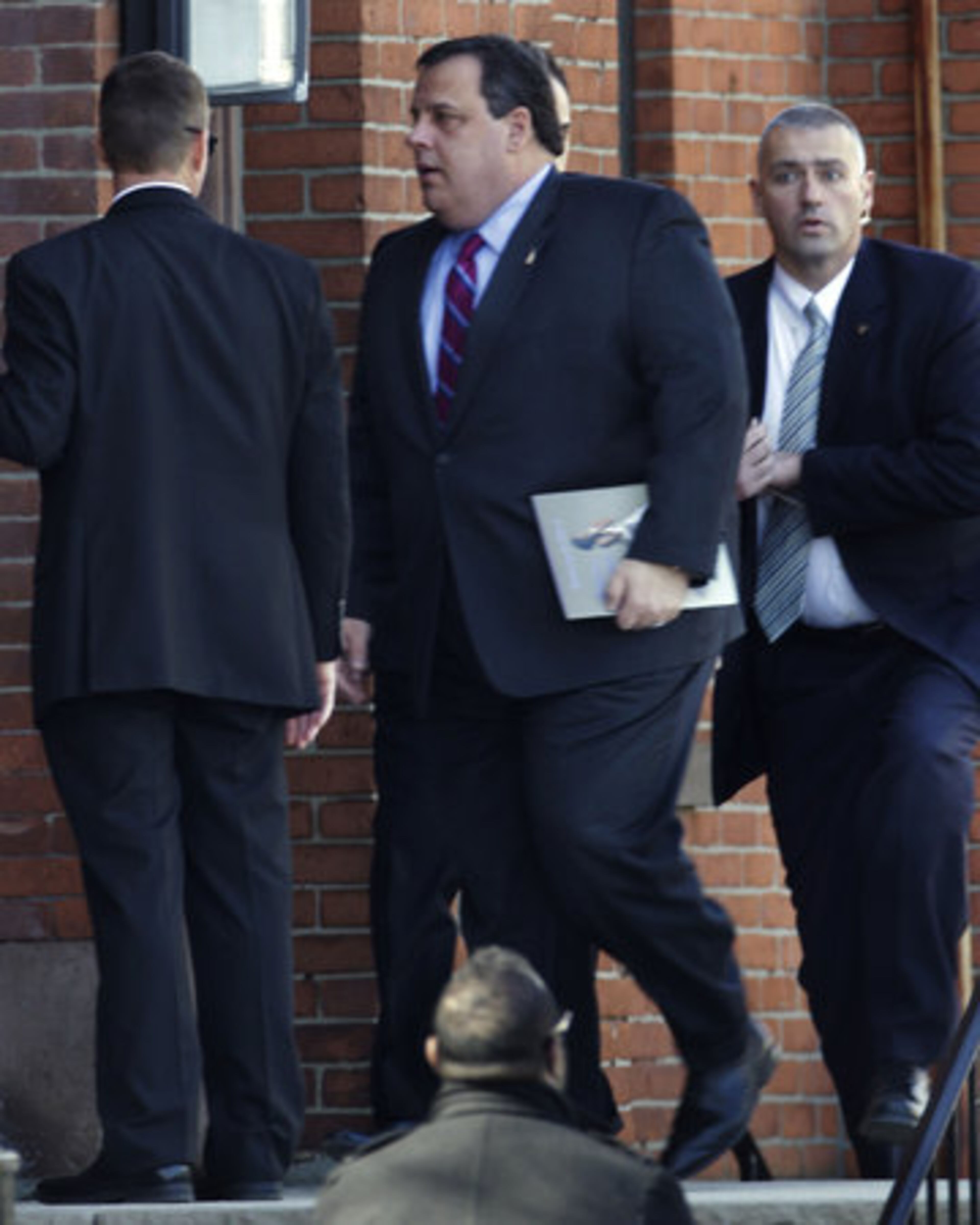 New Jersey Gov. Chris Christie, center, arrives for funeral services for singer Whitney Houston at the New Hope Baptist Church in Newark, N.J., Saturday, Feb. 18, 2012.