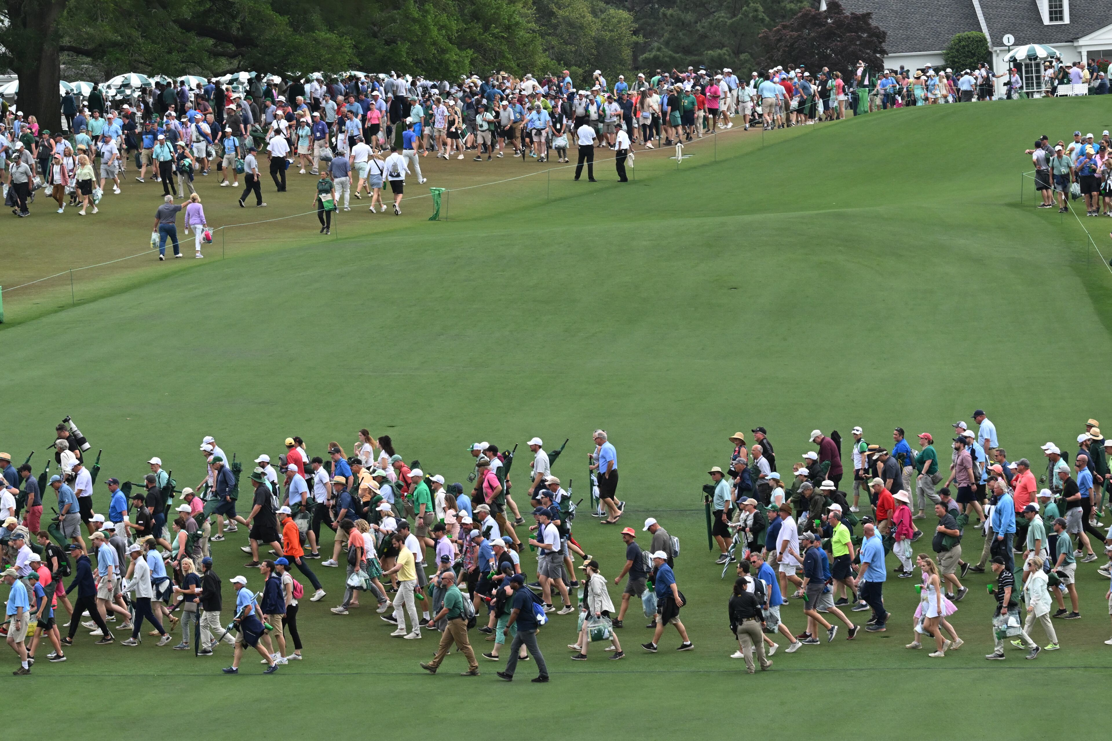 Patrons leave the course following suspension of play during second round of the 2023 Masters Tournament at Augusta National Golf Club, Friday, April 7, 2023, in Augusta, Ga. (Hyosub Shin / Hyosub.Shin@ajc.com)