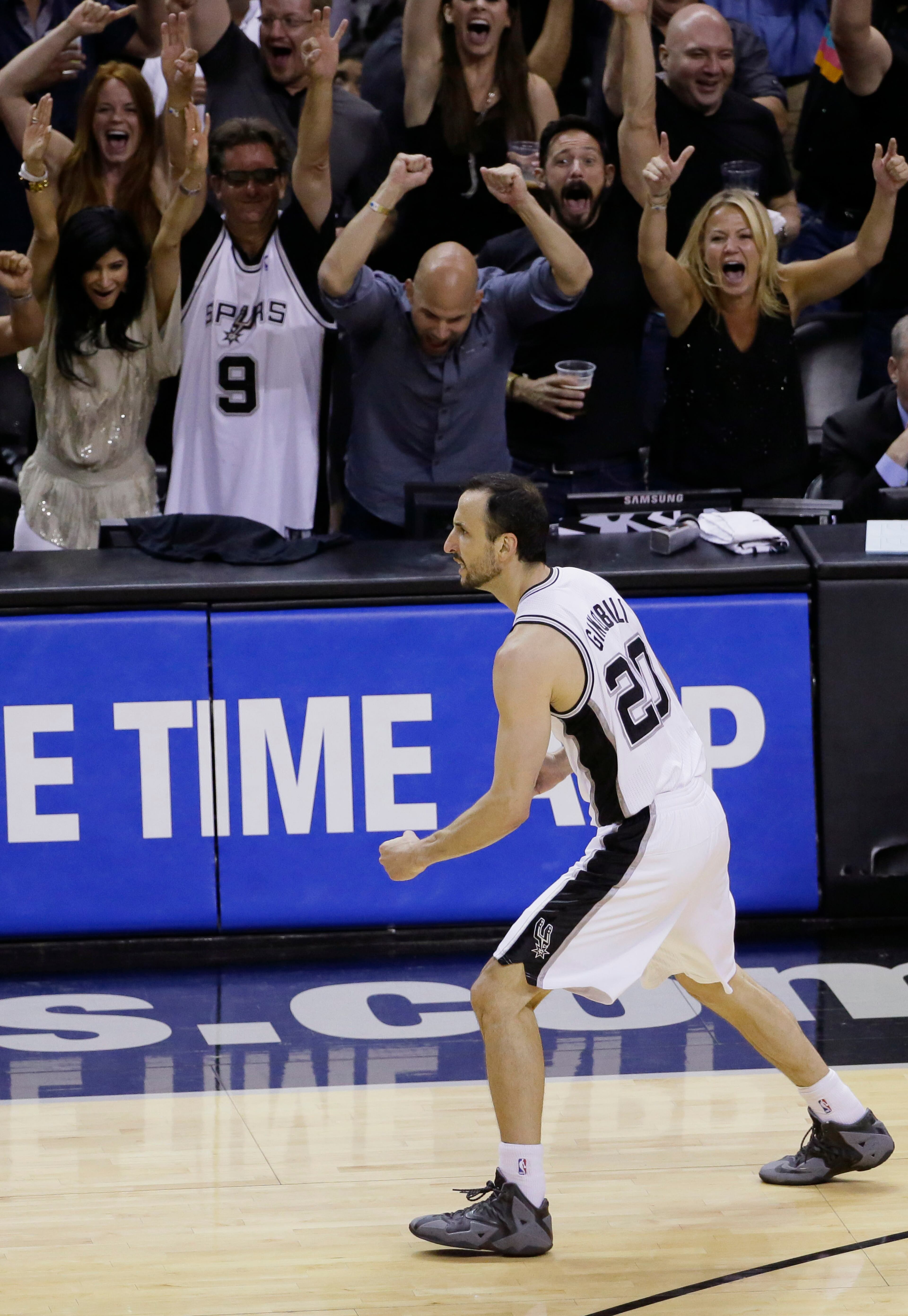 San Antonio Spurs guard Manu Ginobili (20) celebrates against the Miami Heat during the second half in Game 5 of the NBA basketball finals on Sunday, June 15, 2014, in San Antonio. (AP Photo/Tony Gutierrez)