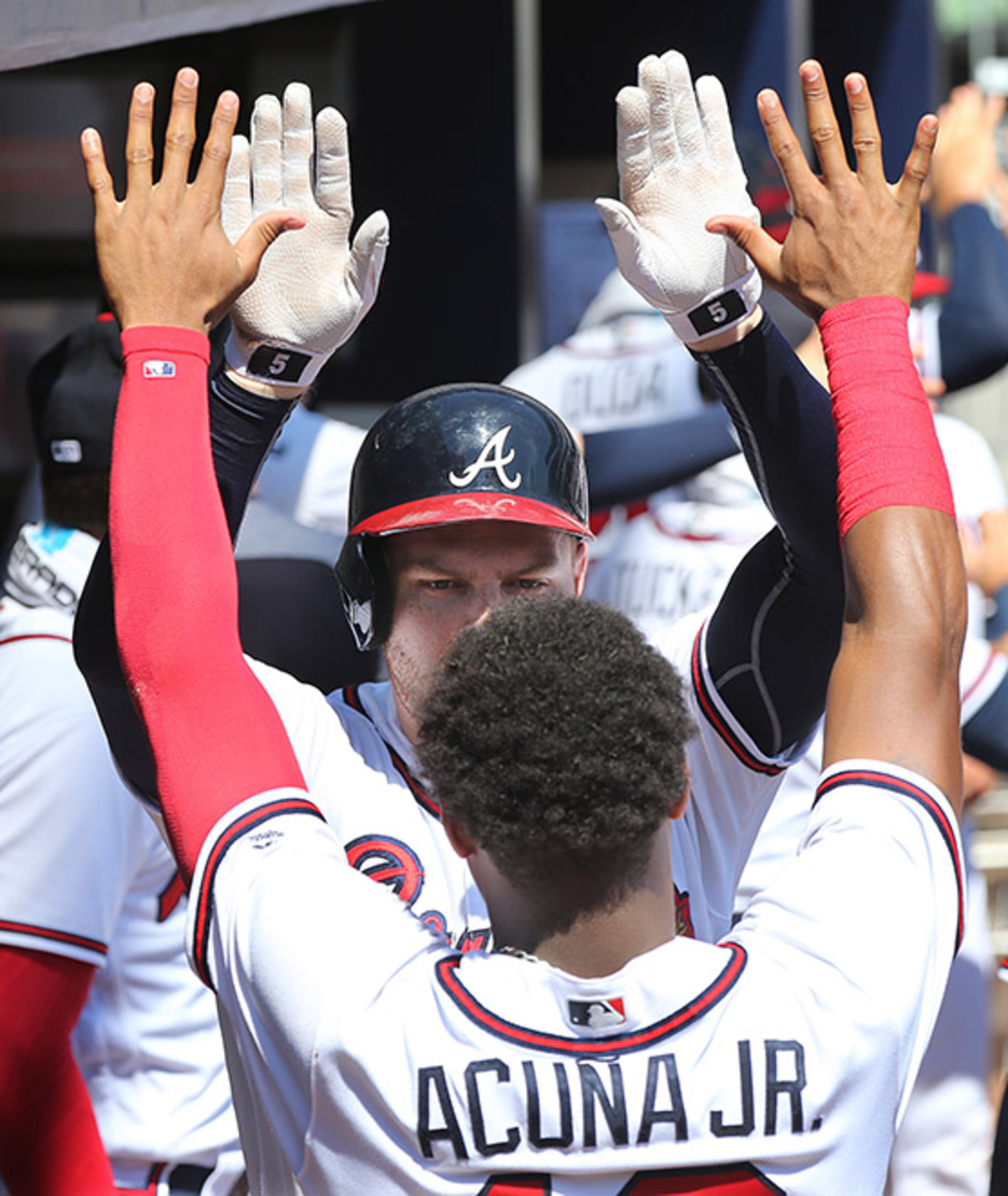 Atlanta Braves Freddie Freeman gets a high-five from Ronald Acuna in the dugout after hitting a 2-run homer to take a 2-0 lead over the St. Louis Cardinals during the fourth inning Wednesday, Sept. 19, 2018, at SunTrust Park in Atlanta.