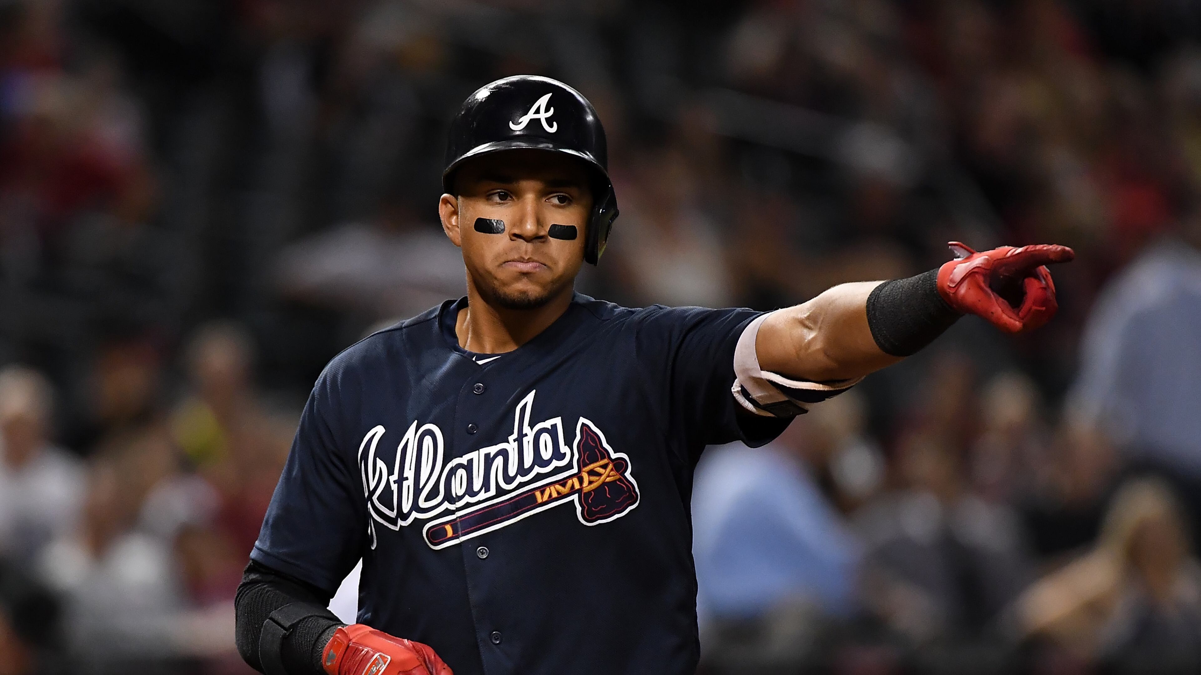 PHOENIX, AZ - JULY 25: Johan Camargo #17 of the Atlanta Braves points to his teammates after hitting a eighth inning home run against the Arizona Diamondbacks at Chase Field on July 25, 2017 in Phoenix, Arizona. Braves won 8-3. (Photo by Norm Hall/Getty Images)