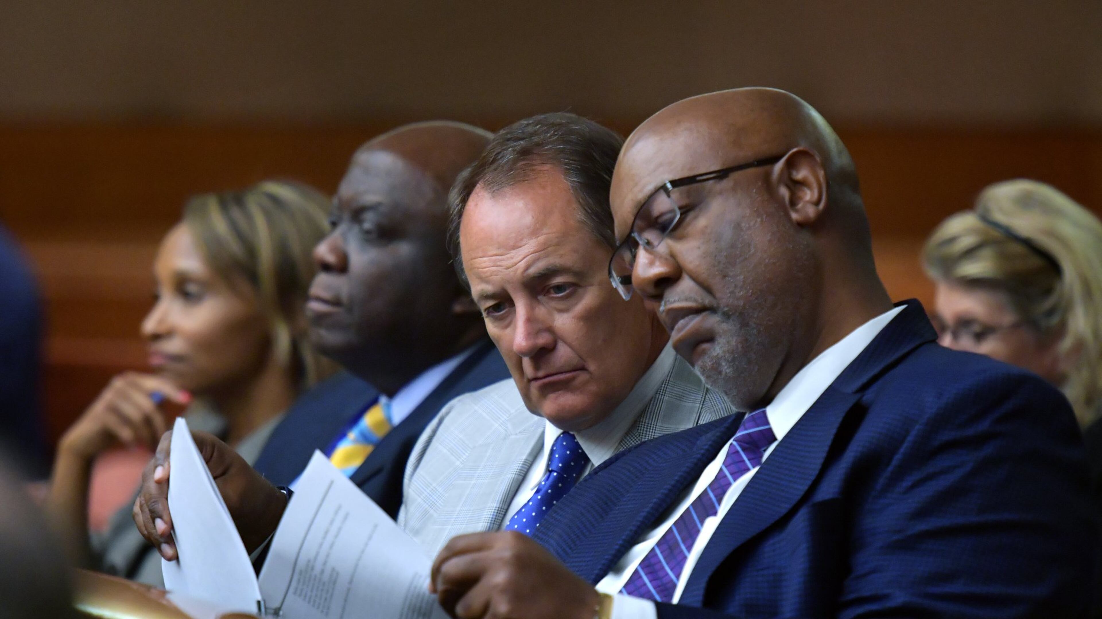 Fulton County Manager Dick Anderson and Dwight Robinson (right), Fulton County’s chief appraiser, share documentations as they listen to a plea to allow Fulton County to collect tax money. HYOSUB SHIN / HSHIN@AJC.COM AJC FILE PHOTO
