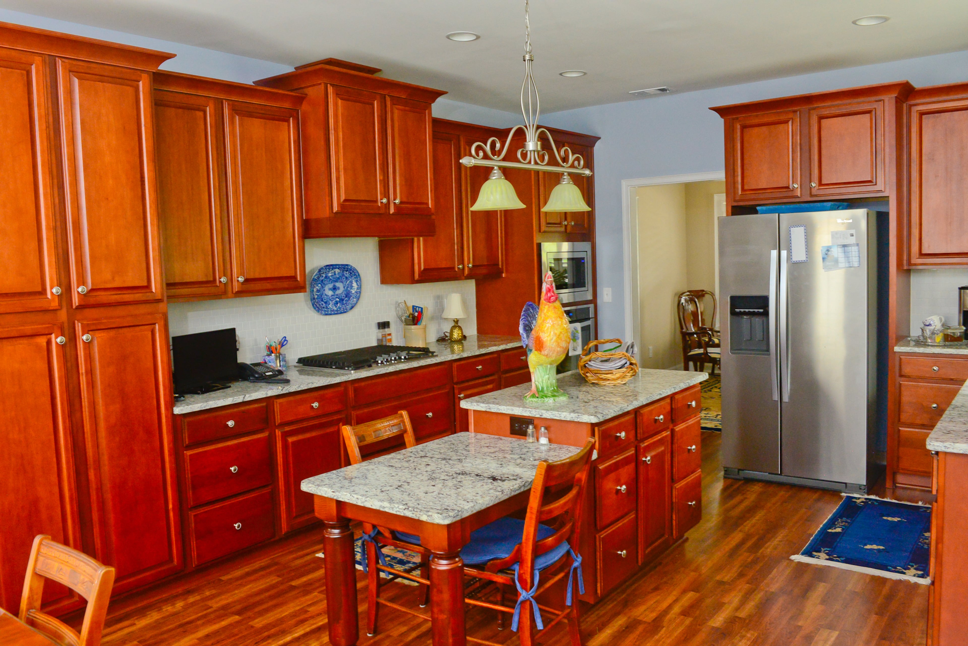 When Chris and Linda moved in, they refreshed the floors, kitchen cabinets and appliances and bathrooms. The couple selected granite countertops for the kitchen and cherry cabinets, similar to the color of those in their last home.