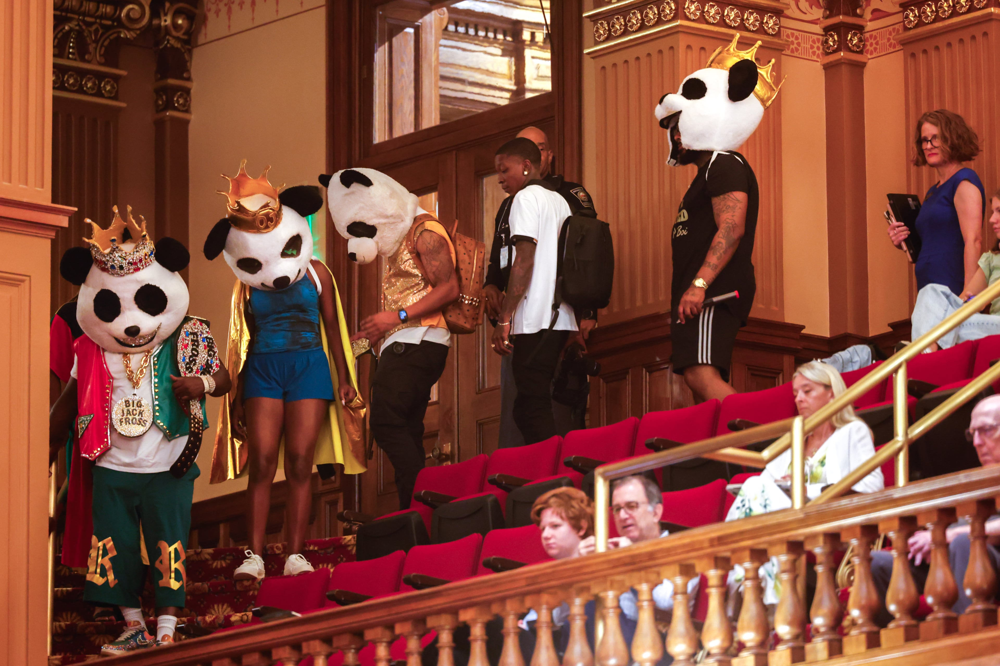 Rapper Big Jack Fross and the Heroes enter the gallery of the House of Representatives during the special session at the Capitol in Atlanta on Saturday. (Arvin Temkar/AJC)
