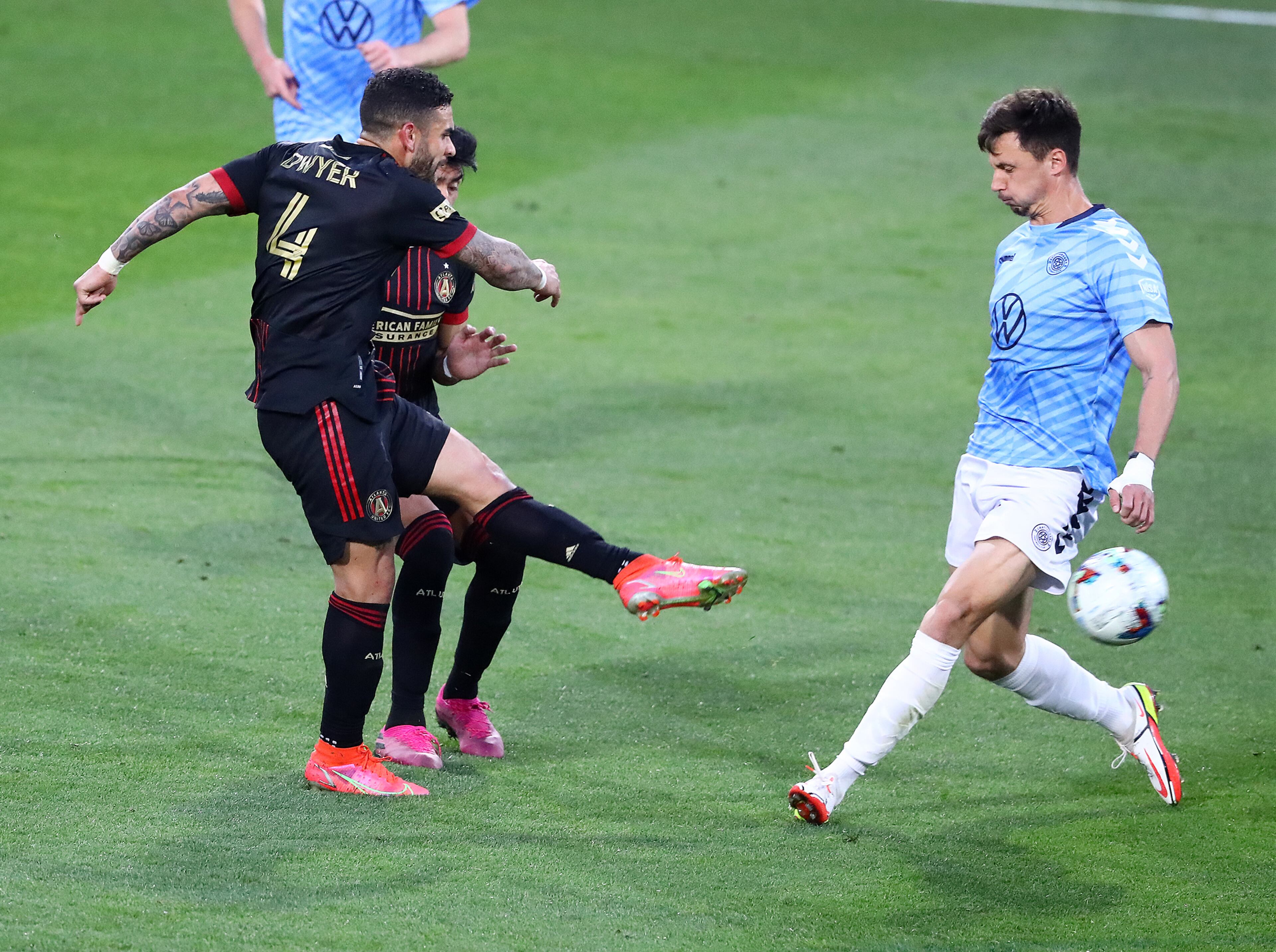 Atlanta United attacker Dom Dwyer scores an unassisted goal past Chattanooga FC defender Colin Stripling to take a 3-0 lead in the Lamar Hunt U.S. Open Cup on Wednesday, April 20, 2022, in Kennesaw. “Curtis Compton / Curtis.Compton@ajc.com”