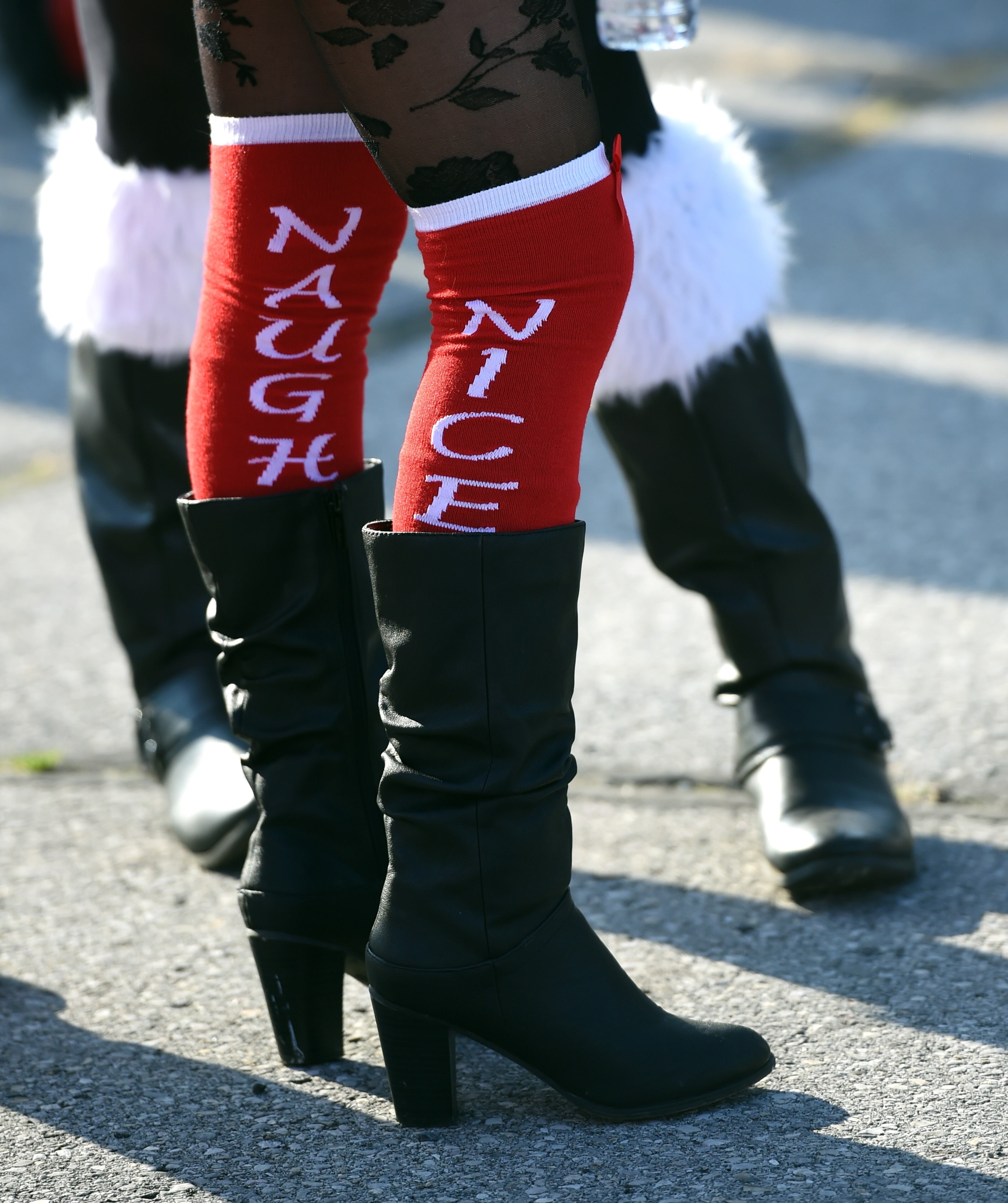 People dressed as Santa or other holiday related outfits around the Brooklyn section of the city during the SantaCon 2015 in New York City December 12, 2015. 2015 is the 21st anniversary of SantaCon, a event where groups of men and woman dress as Santa . AFP PHOTO / TIMOTHY A. CLARY / AFP / TIMOTHY A. CLARY (Photo credit should read TIMOTHY A. CLARY/AFP/Getty Images)