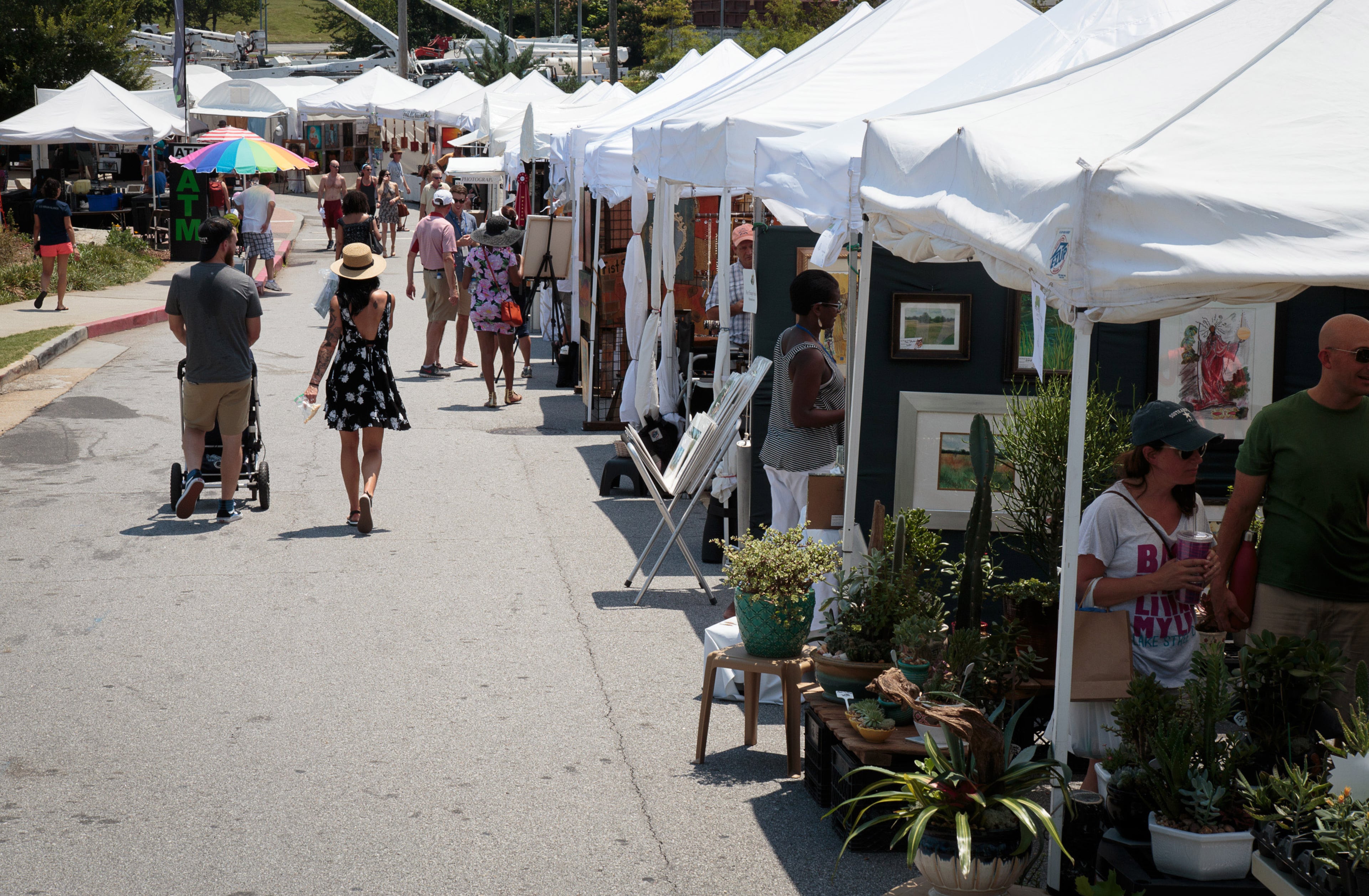 Shoppers walk along the row of artist tents during the Old Fourth Ward Park Arts Festival in Atlanta, Ga. Saturday, June 25, 2016. STEVE SCHAEFER / SPECIAL TO THE AJC