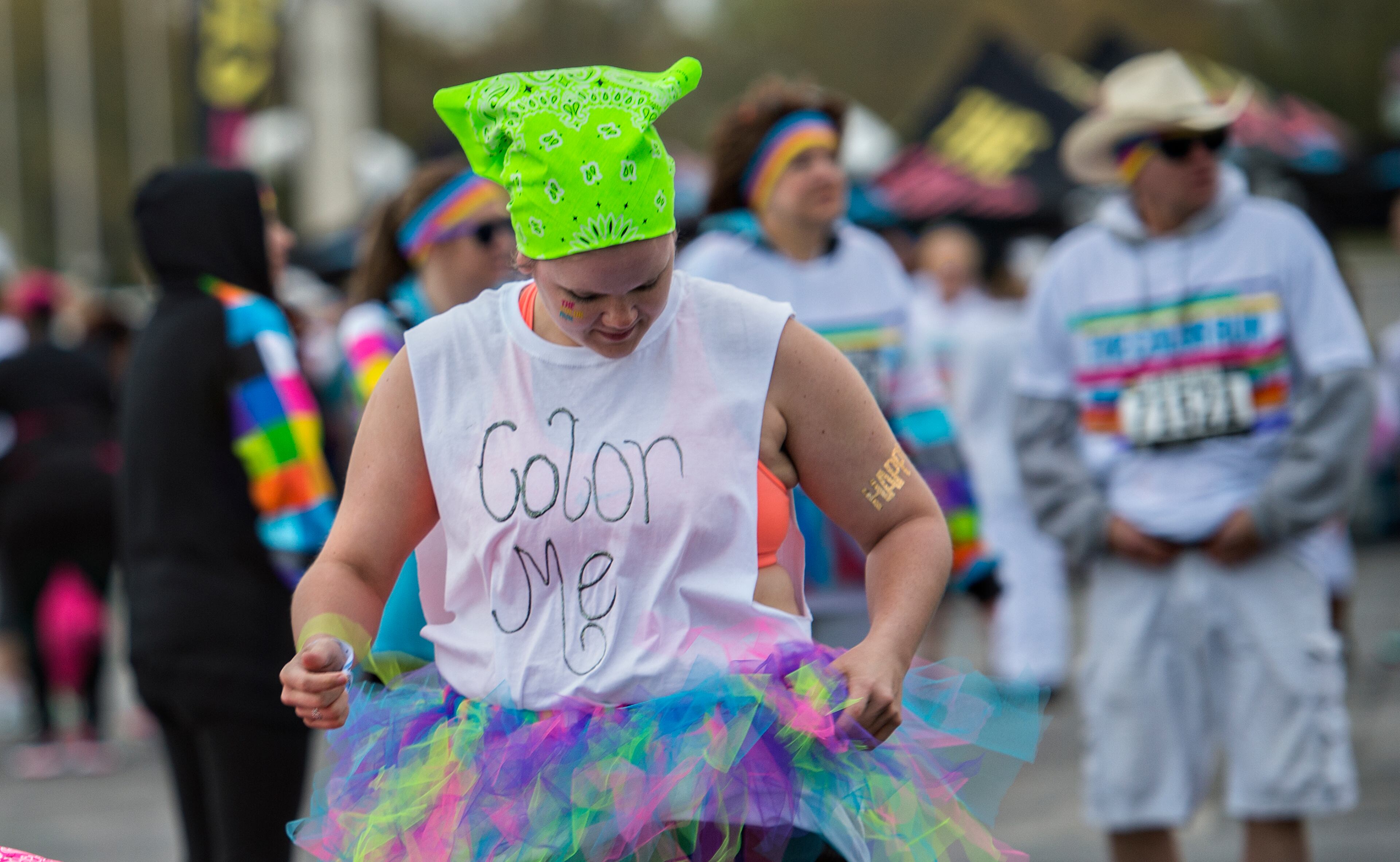 Katie Tiner adjusts her tutu before the start of The Color Run at Atlanta Motor Speedway in Hampton on Saturday, April 4, 2015. Thousands of people participated in the 5k which had five stations of different colors that racers were doused in as they made their way through the course. JONATHAN PHILLIPS / SPECIAL