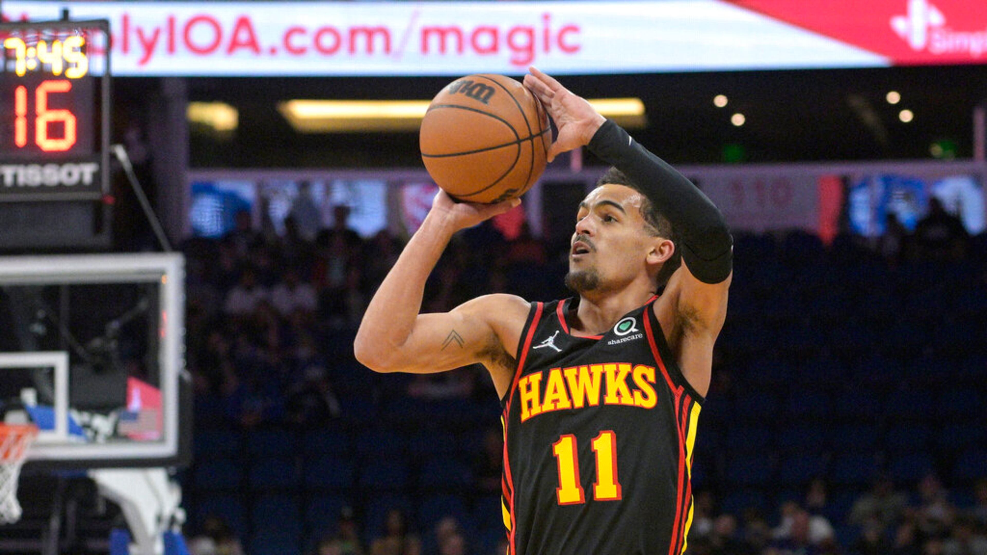 Atlanta Hawks guard Trae Young shoots a 3-pointer during the first half of the team's NBA basketball game against the Orlando Magic, Wednesday, Feb. 16, 2022, in Orlando, Fla. (AP Photo/Phelan M. Ebenhack)