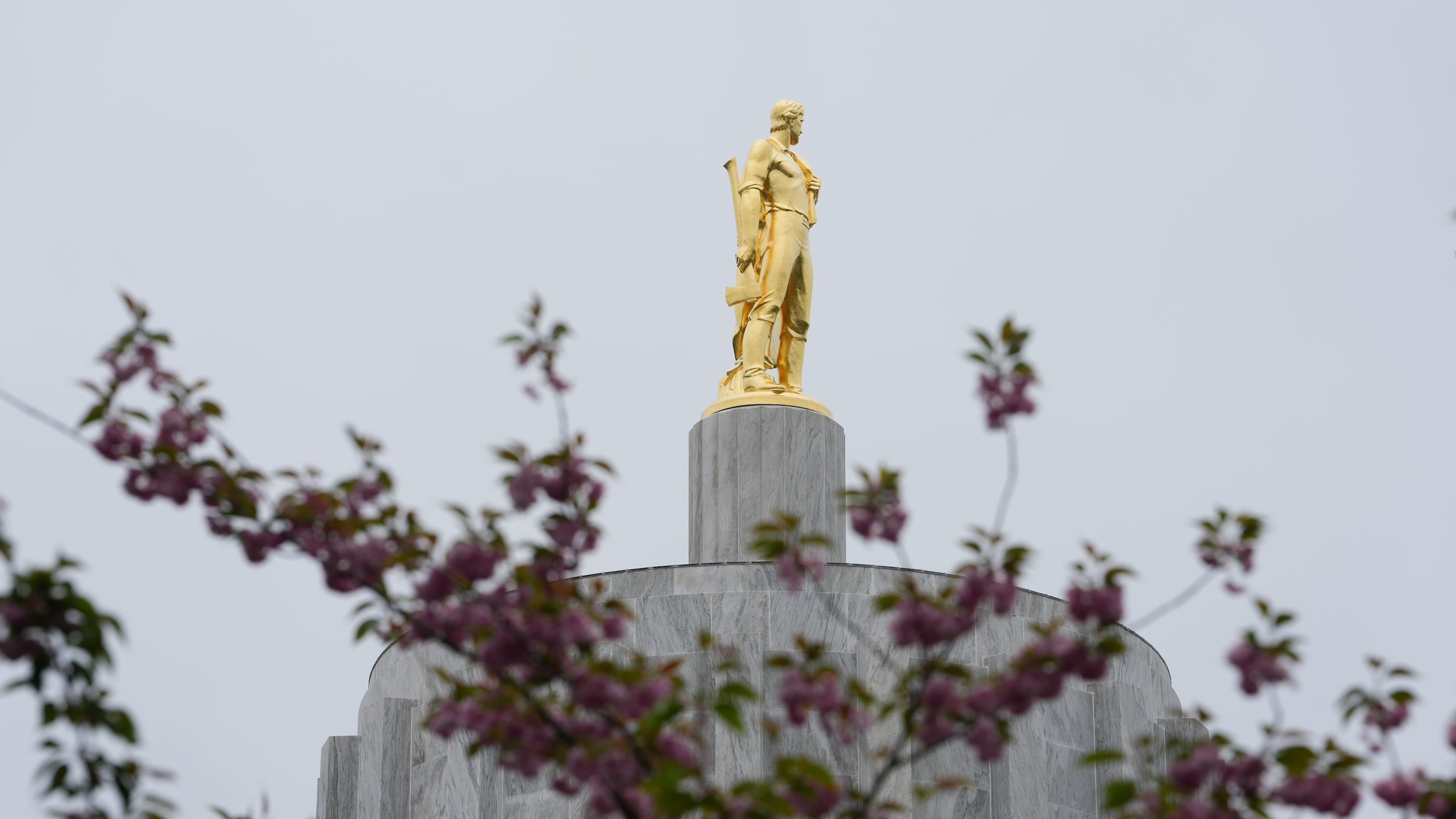 FILE - The Oregon Pioneer statue is seen on top of the Oregon State Capitol building, April 14, 2026, in Salem, Ore. (AP Photo/Jenny Kane, File)