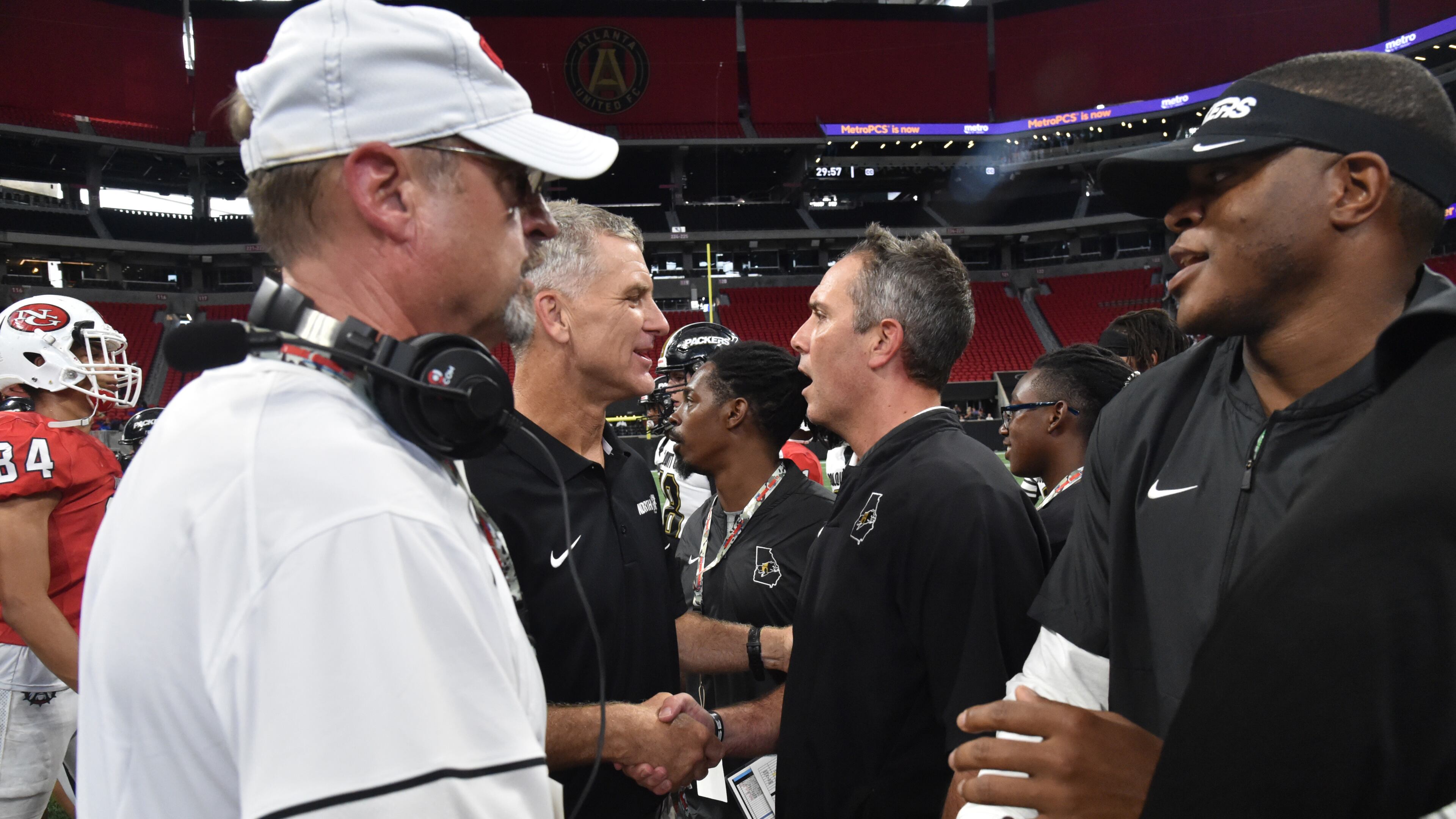 North Gwinnett head coach Bill Stewart (center left) and Colquitt County head coach Justin Rogers shake hands after Colquitt County won 17- 6 during the Corky Kell Classic at Mercedes-Benz Stadium on Saturday, August 24, 2019. (Hyosub Shin / Hyosub.Shin@ajc.com)