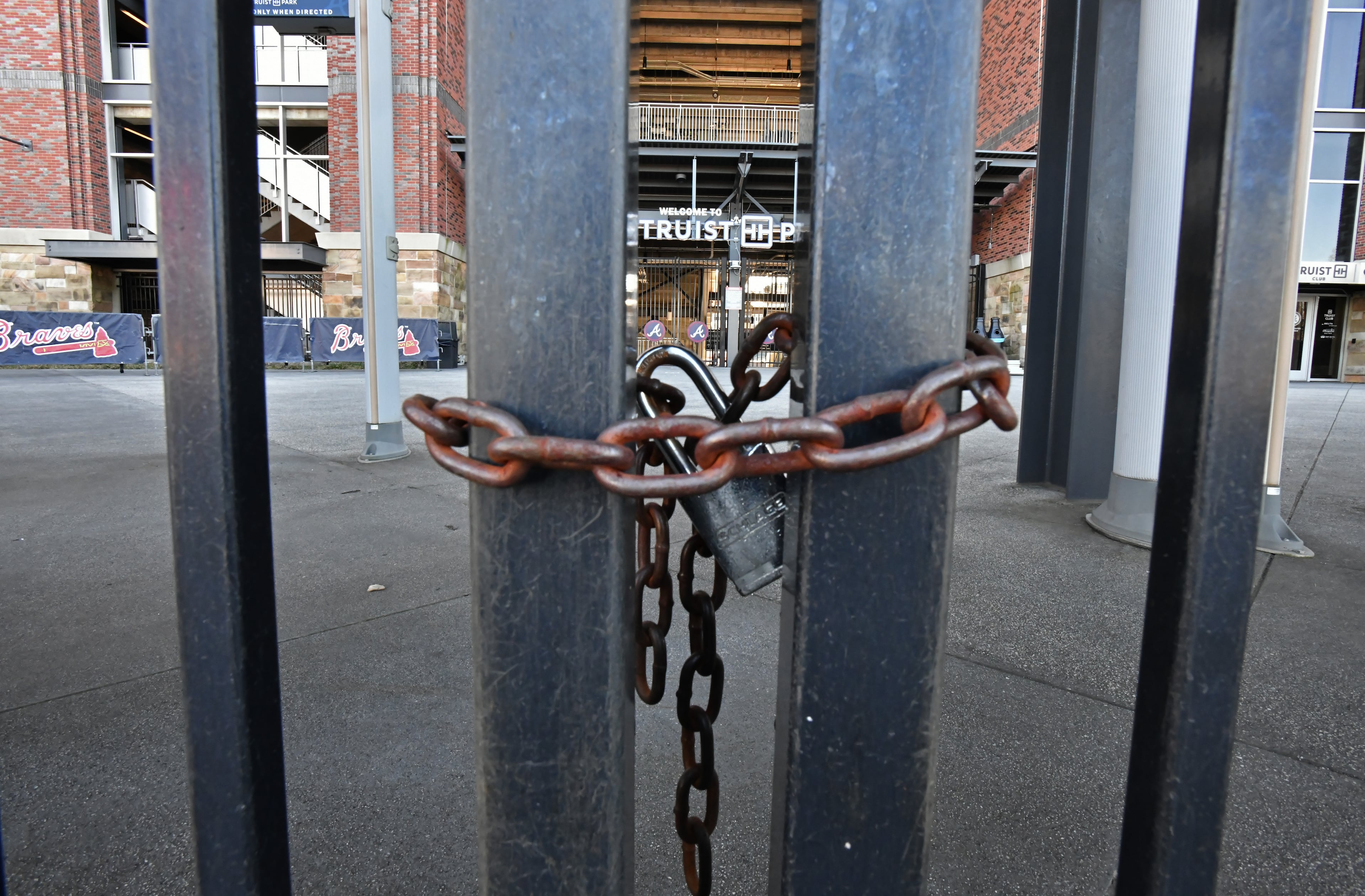 Third-base gates at Truist Park are locked on Wednesday, March 2, 2022. (Hyosub Shin / Hyosub.Shin@ajc.com)